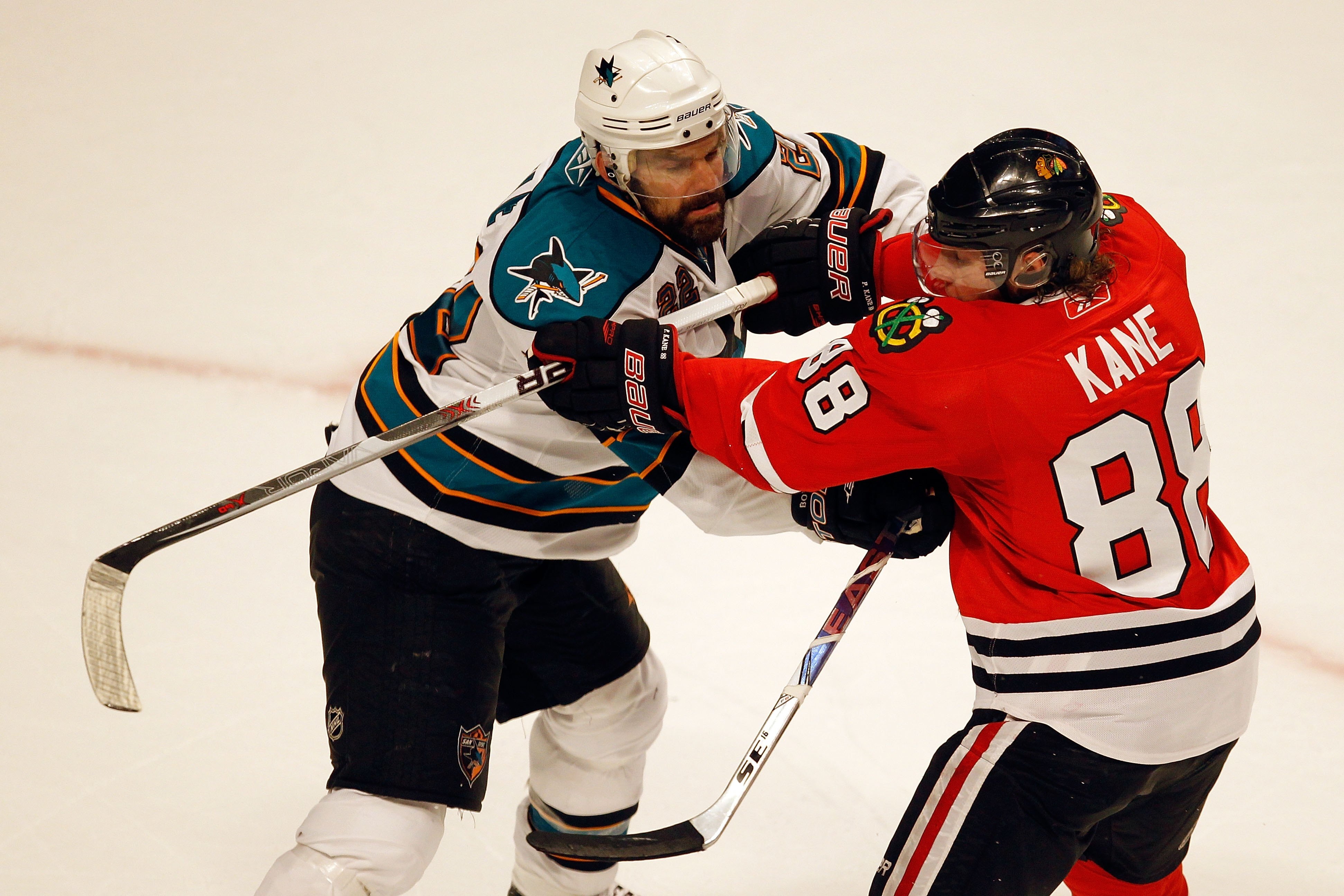 CHICAGO - MAY 23:  Dan Boyle #22 of the San Jose Sharks checks Patrick Kane #88 of the Chicago Blackhawks in Game Four of the Western Conference Finals during the 2010 NHL Stanley Cup Playoffs at the United Center on May 23, 2010 in Chicago, Illinois.  (P