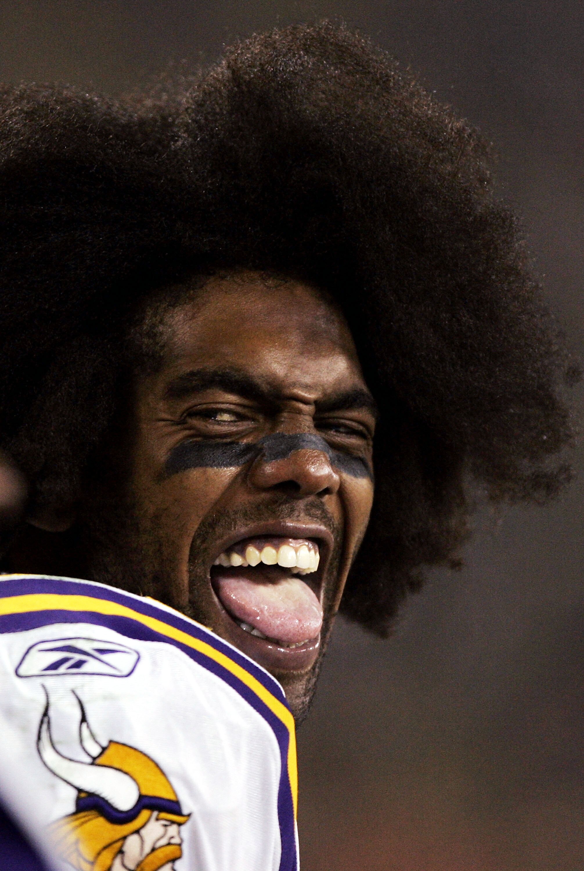 GREEN BAY, WI - JANUARY 9:  Wide reciever Randy Moss #84 of the Minnesota Vikings jokes with teammates on the sideline while taking on the Green Bay Packers in the NFC wild-card game at Lambeau Field on January 9, 2005 in Green Bay, Wisconsin.  The Viking