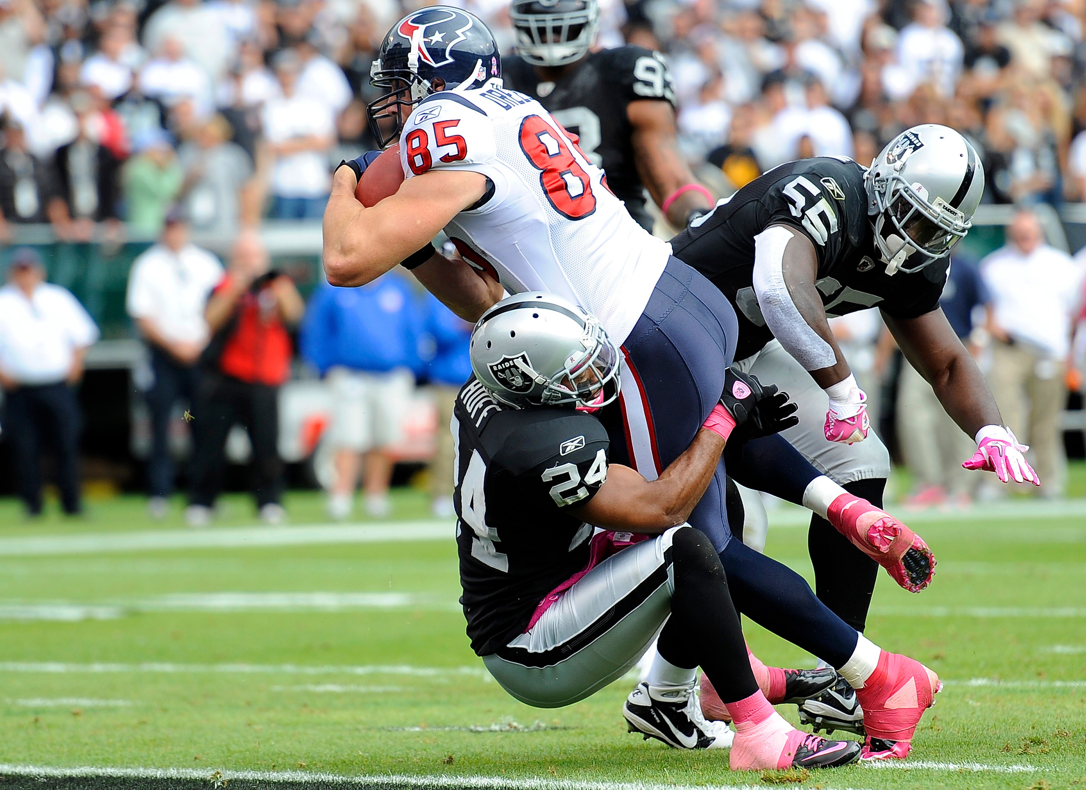 OAKLAND, CA - OCTOBER 3: Tighe End Joel Dreesen #85 of the Houston Texans runs over Michael Huff #24 of the Oakland Raiders into the endzone for a touchdown during an NFL football game October 3, 2010 at The Oakland-Alameda County Coliseum in Oakland, Cal