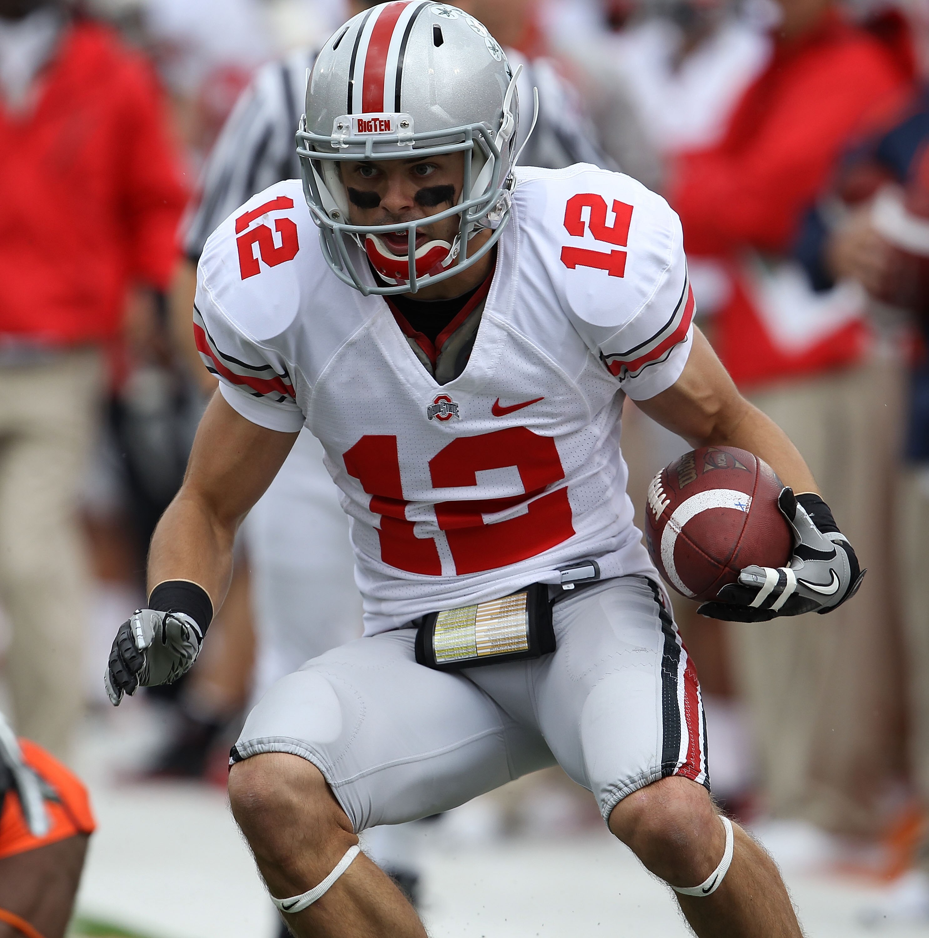 CHAMPAIGN, IL - OCTOBER 02: Dane Sanzenbacher #12 of the Ohio State Buckeyes runs after catching a pass against the Illinois Fighting Illini at Memorial Stadium on October 2, 2010 in Champaign, Illinois. Ohio State defeated Illinois 24-13. (Photo by Jonat