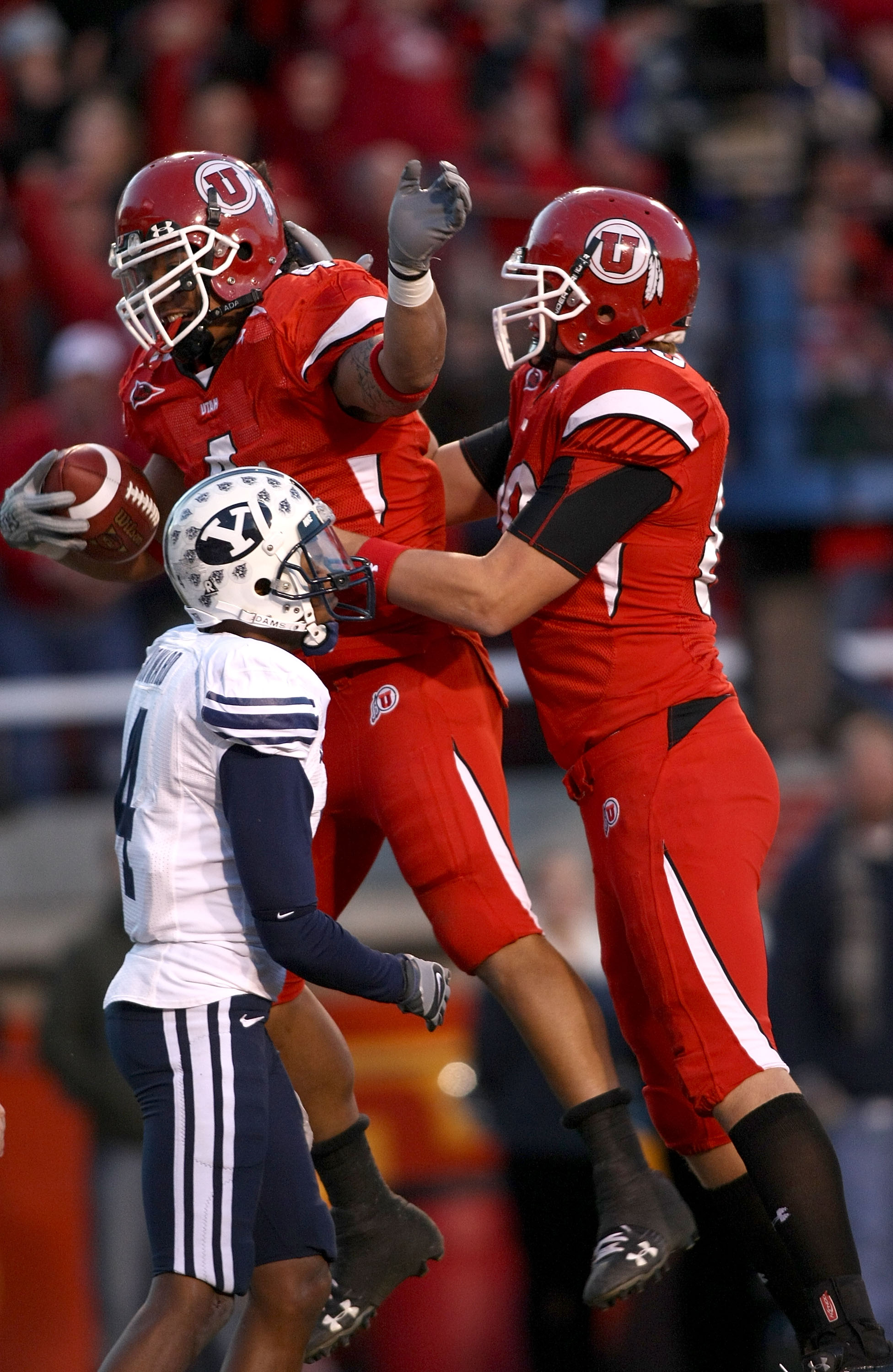 SALT LAKE CITY - NOVEMBER 22:    Matt Asiata #4 of the Utah Utes celebrates with Chris Joppru #80 after scoring a touchdown against the BYU Cougars at Rice-Eccles Stadium on November 22, 2008 in Salt Lake City, Utah.  (Photo by Jonathan Ferrey/Getty Image