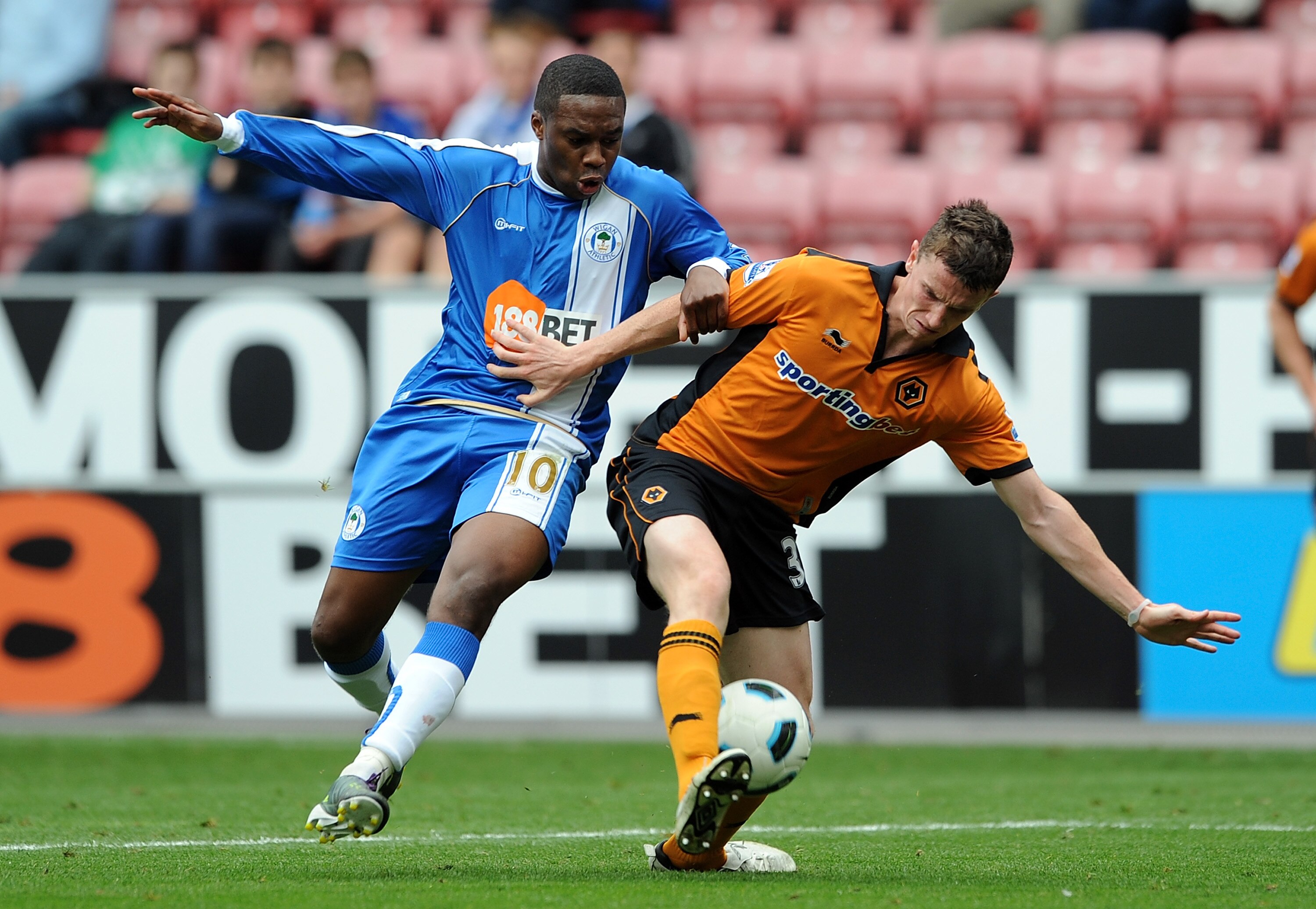 WIGAN, ENGLAND - OCTOBER 02: Charles N'Zogbia of Wigan Athletic competes with Kevin Foley of Wolverhampton Wanderers during the Barclays Premier League match between Wigan Athletic and Wolverhampton Wanderers at DW Stadium on October 2, 2010 in Wigan, Eng WIGAN, ENGLAND - OCTOBER 02: Charles N'Zogbia of Wigan Athletic competes with Kevin Foley of Wolverhampton Wanderers during the Barclays Premier League match between Wigan Athletic and Wolverhampton Wanderers at DW Stadium on October 2, 2010 in Wigan, Eng