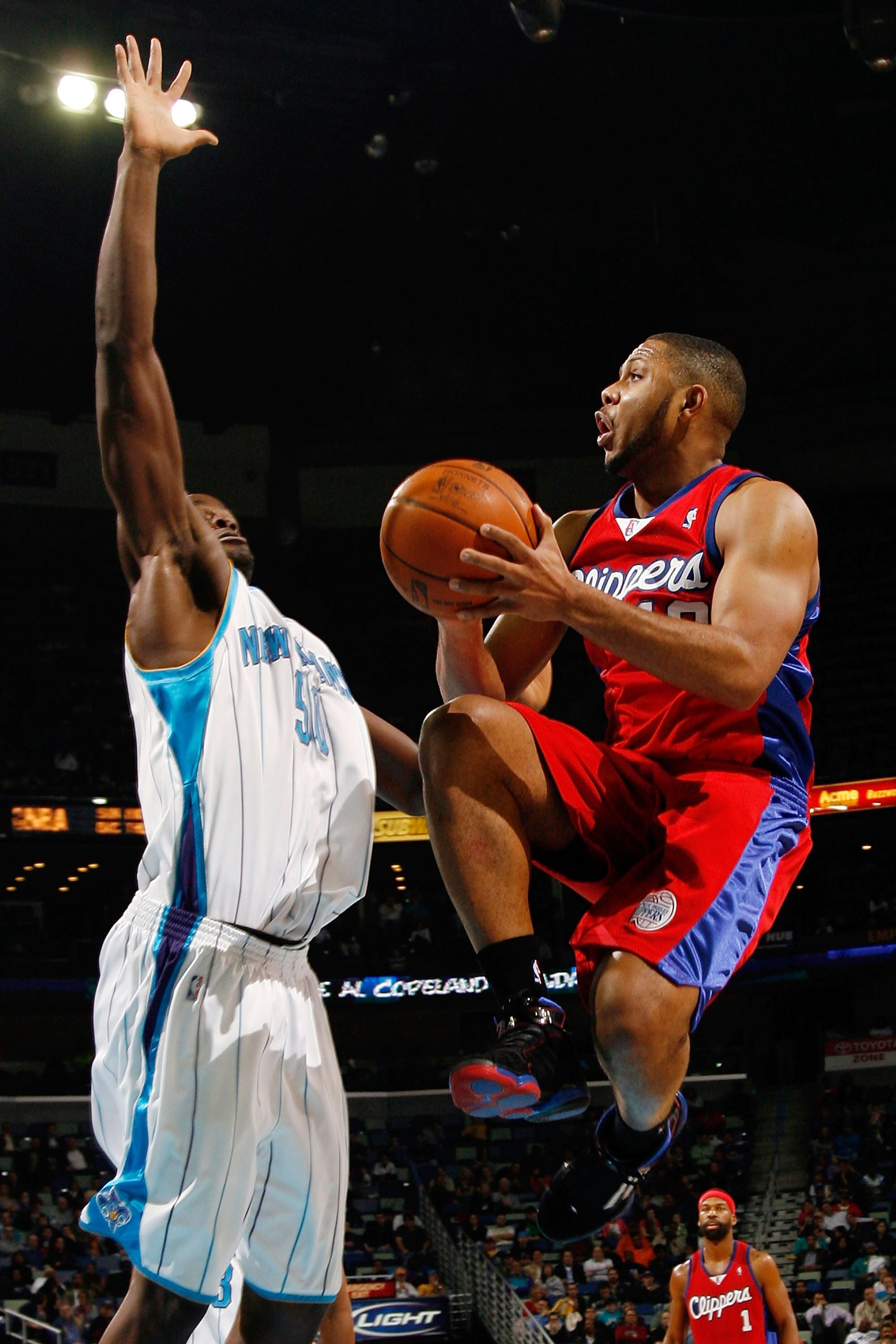 NEW ORLEANS - JANUARY 13:  Eric Gordon #10 of the Los Angeles Clippers tries to make a shot over Emeka Okafor #50 of the New Orleans Hornets at the New Orleans Arena on January 13, 2010 in New Orleans, Louisiana.  The Hornets defeated the Clippers 108-94.