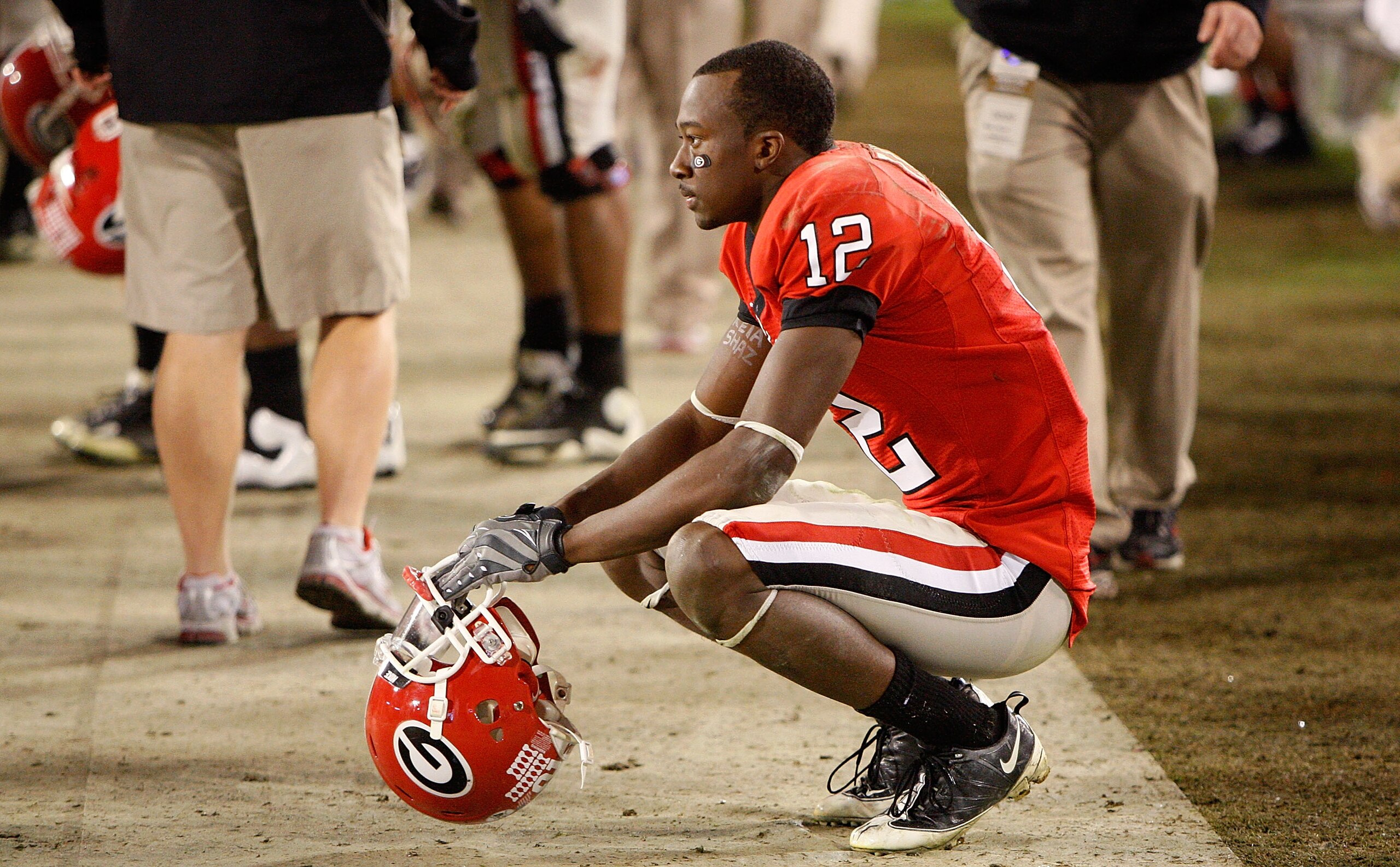 ATHENS, GA - NOVEMBER 21:  Tavarres King #12 of the Georgia Bulldogs squats dejected on the sideline after an interception by the Kentucky Wildcats in the final minutes of their 34-27 loss at Sanford Stadium on November 21, 2009 in Athens, Georgia.  (Phot