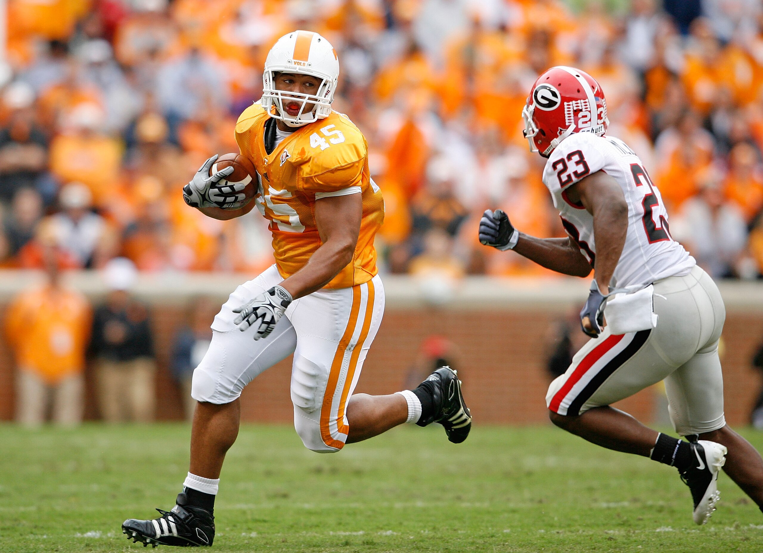 KNOXVILLE, TN - OCTOBER 10: Kevin Cooper #45 of the Tennessee Volunteers runs with the ball while defended by Prince Miller #23 of the Georgia Bulldogs during the SEC game at Neyland Stadium on October 10, 2009 in Knoxville, Tennessee. (Photo by Andy Lyon