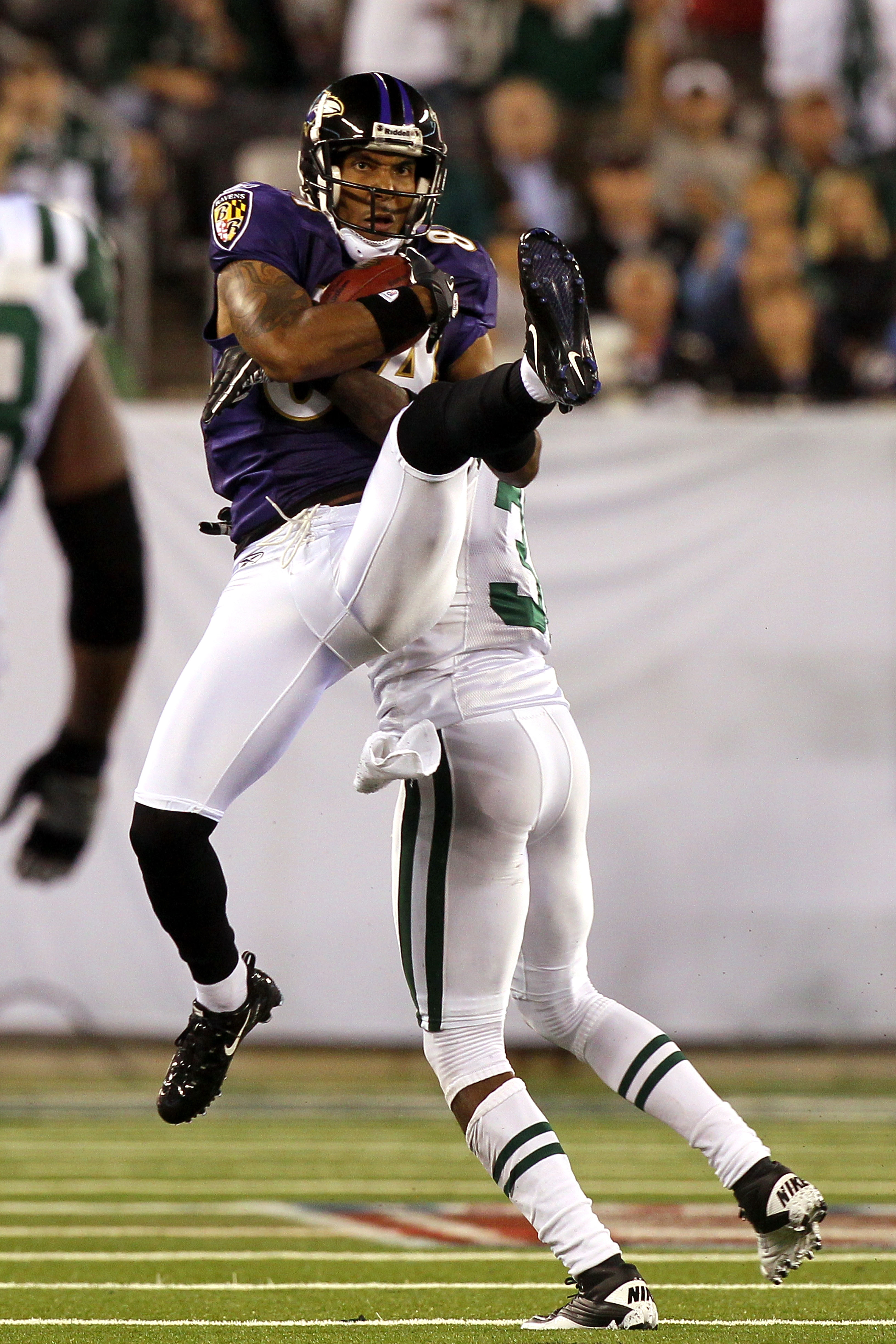 EAST RUTHERFORD, NJ - SEPTEMBER 13:  T.J. Houshmandzadeh #84 of the Baltimore Ravens catches a pass against the New York Jets during their home opener at the New Meadowlands Stadium on September 13, 2010 in East Rutherford, New Jersey.  (Photo by Jim McIs