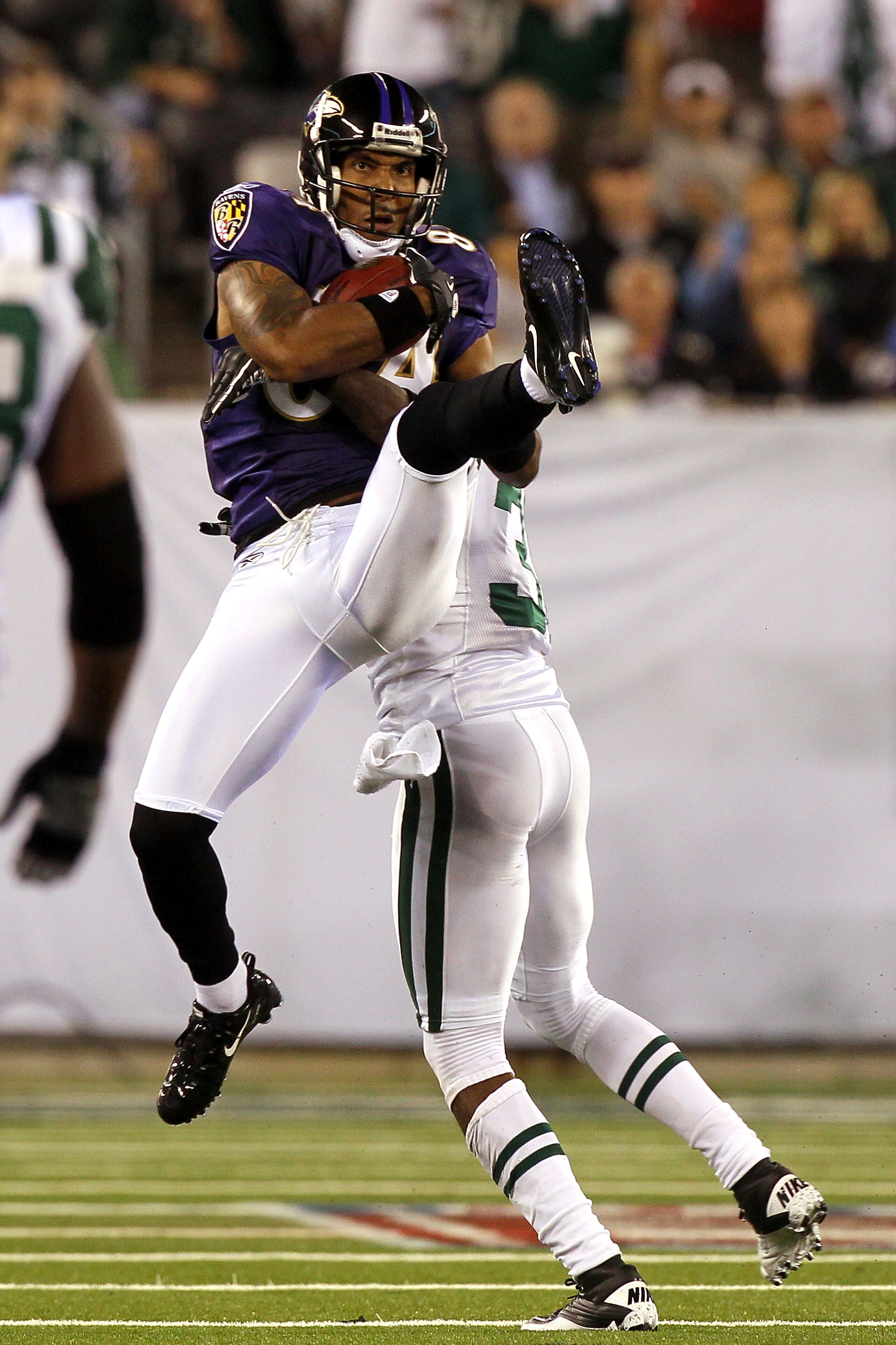 EAST RUTHERFORD, NJ - SEPTEMBER 13:  T.J. Houshmandzadeh #84 of the Baltimore Ravens catches a pass against the New York Jets during their home opener at the New Meadowlands Stadium on September 13, 2010 in East Rutherford, New Jersey.  (Photo by Jim McIs