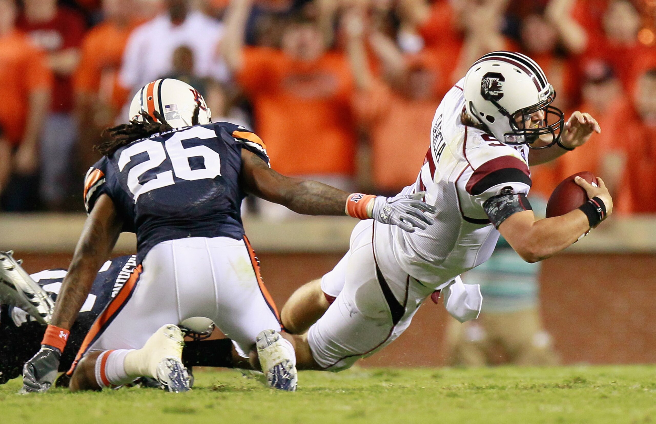 AUBURN, AL - SEPTEMBER 25:  Mike McNeil #26 of the Auburn Tigers defends as Demond Washington #14 sacks quarterback Stephen Garcia #5 of the South Carolina Gamecocks at Jordan-Hare Stadium on September 25, 2010 in Auburn, Alabama.  (Photo by Kevin C. Cox/
