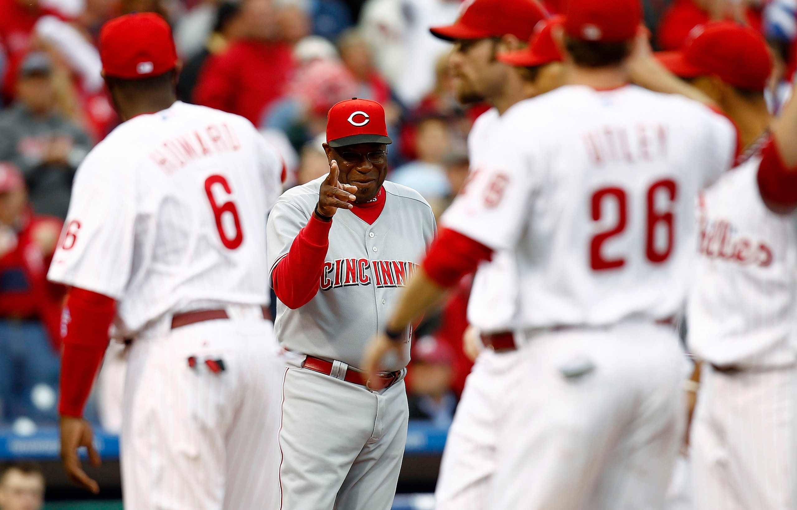 PHILADELPHIA - OCTOBER 06:  Dusty Baker #12, manager of the Cincinnati Reds waves to Ryan Howard #6 of the Philadelphia Phillies before Game 1 of the  NLDS at Citizens Bank Park on October 6, 2010 in Philadelphia, Pennsylvania.  (Photo by Jeff Zelevansky/