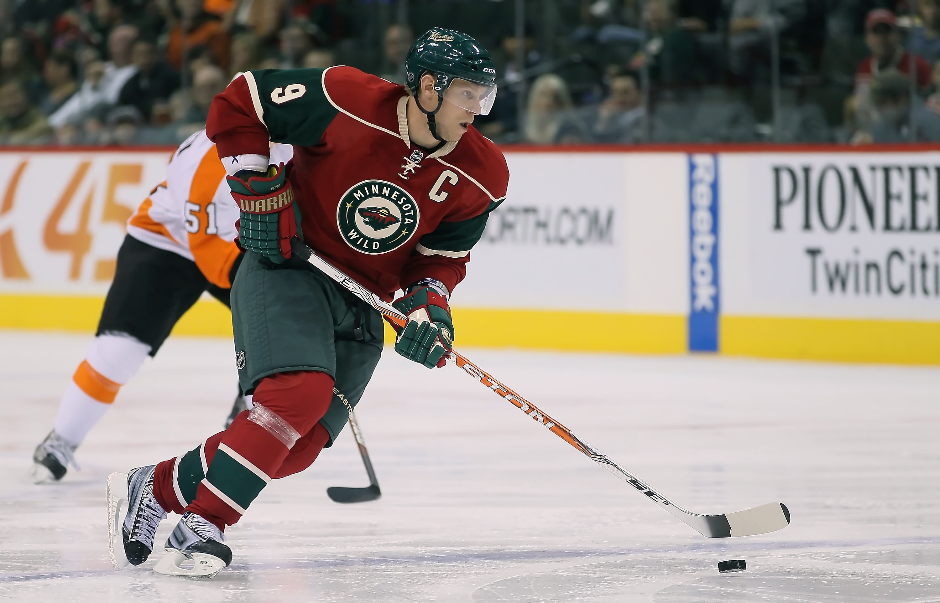 ST PAUL, MN - SEPTEMBER 25:  Mikko Koivu #9 of the Minnesota Wild skates with puck against the Philadelphia Flyers at Xcel Energy Center on September 25, 2010 in St Paul, Minnesota.  (Photo by Jeff Gross/Getty Images)