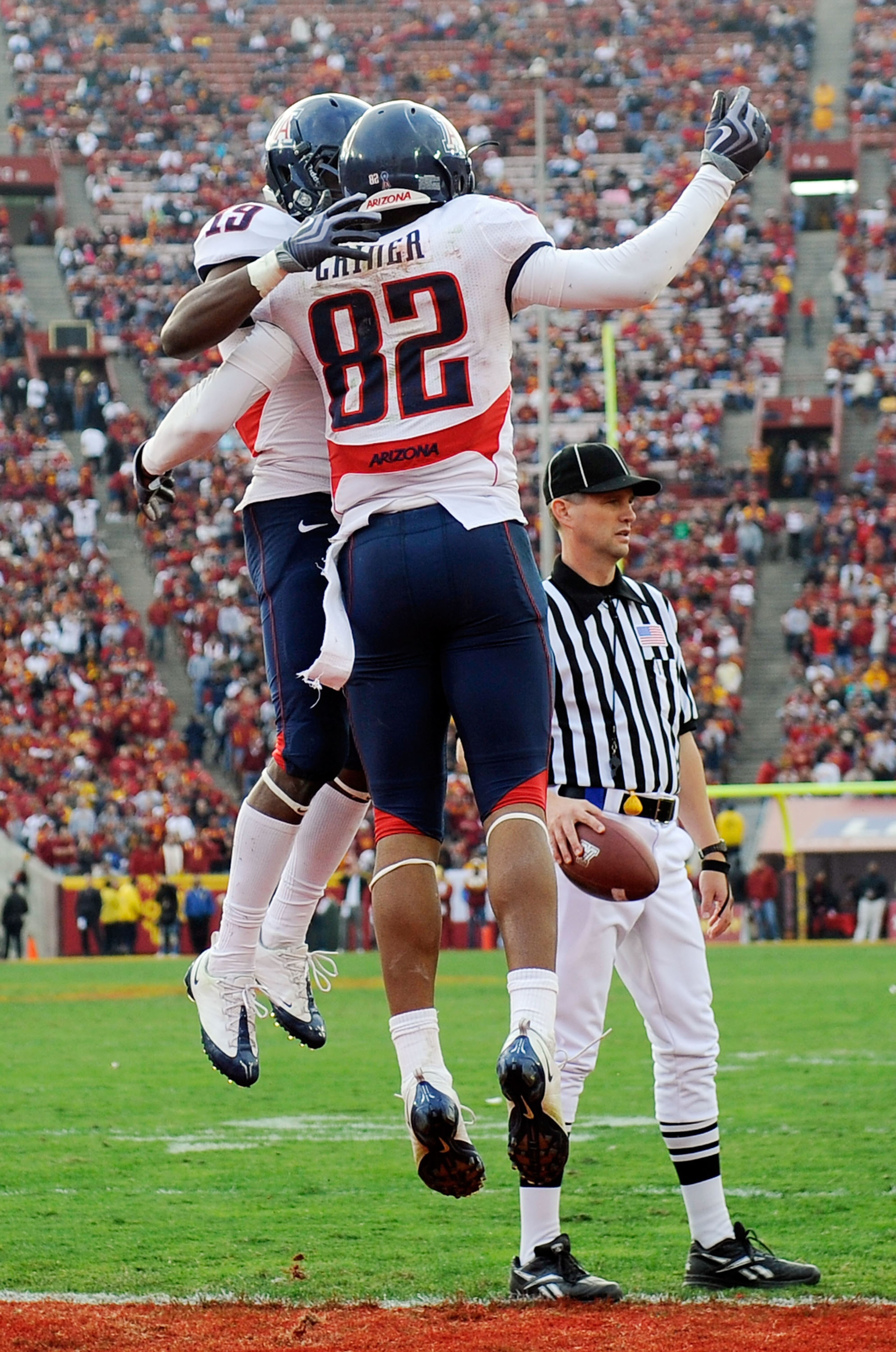 LOS ANGELES, CA - DECEMBER 05:  Wide receiver Juron Criner #82 of the Arizona Wildcats celebrates his game-winning late touchdown with William Wright #19 against the USC Trojans during the NCAA college football game at the Los Angeles Coliseum on December