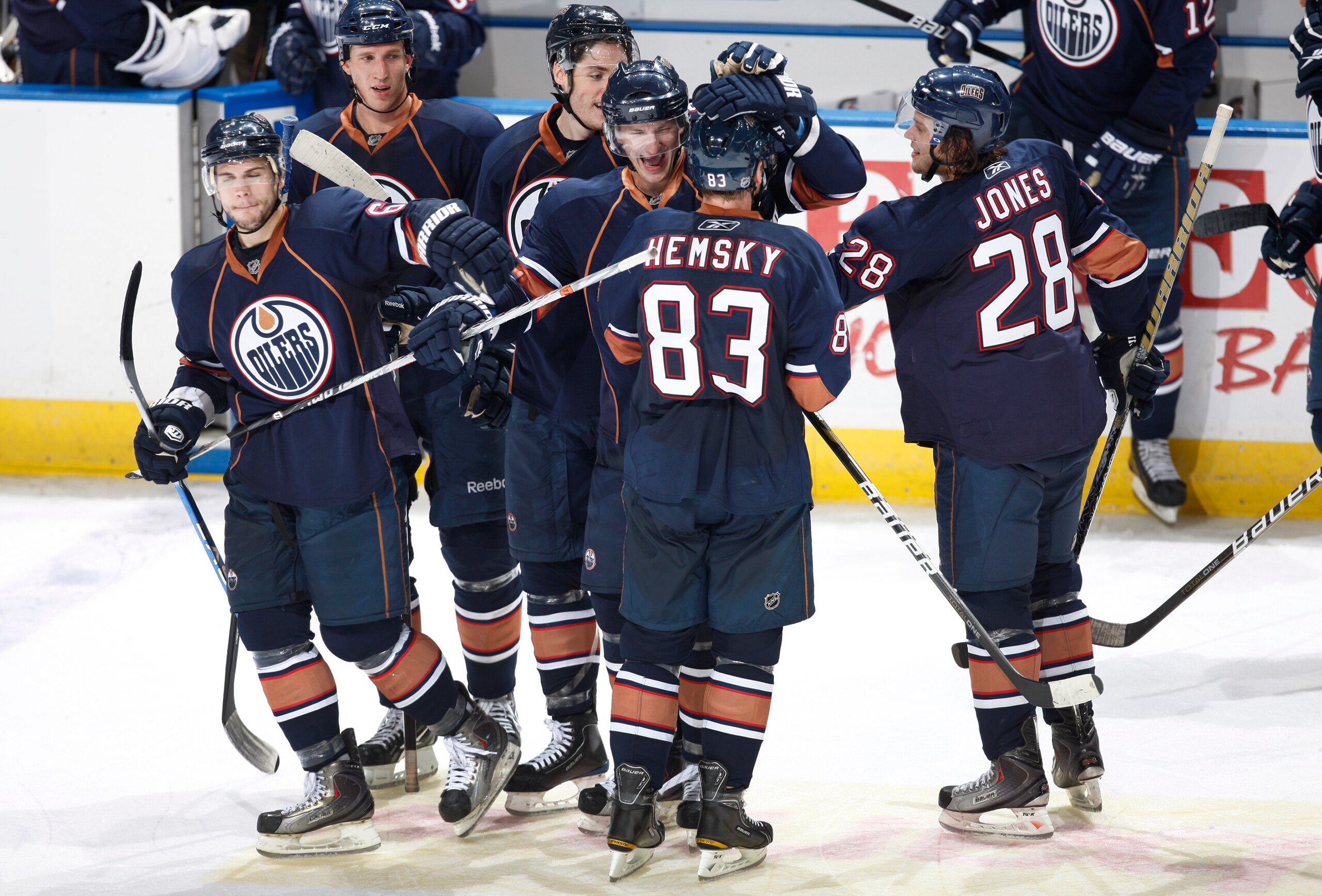 ALBERTA, CANADA - SEPTEMBER 29: Ales Hemsky #83 of the Edmonton Oilers is congratulated after scoring in a shootout by teammates Ladislav Smid #5, Gilbert Brule #67 and Ryan Jones #28 against the Phoenix Coyotes. The oilers went on to win 4-3.  on Septemb