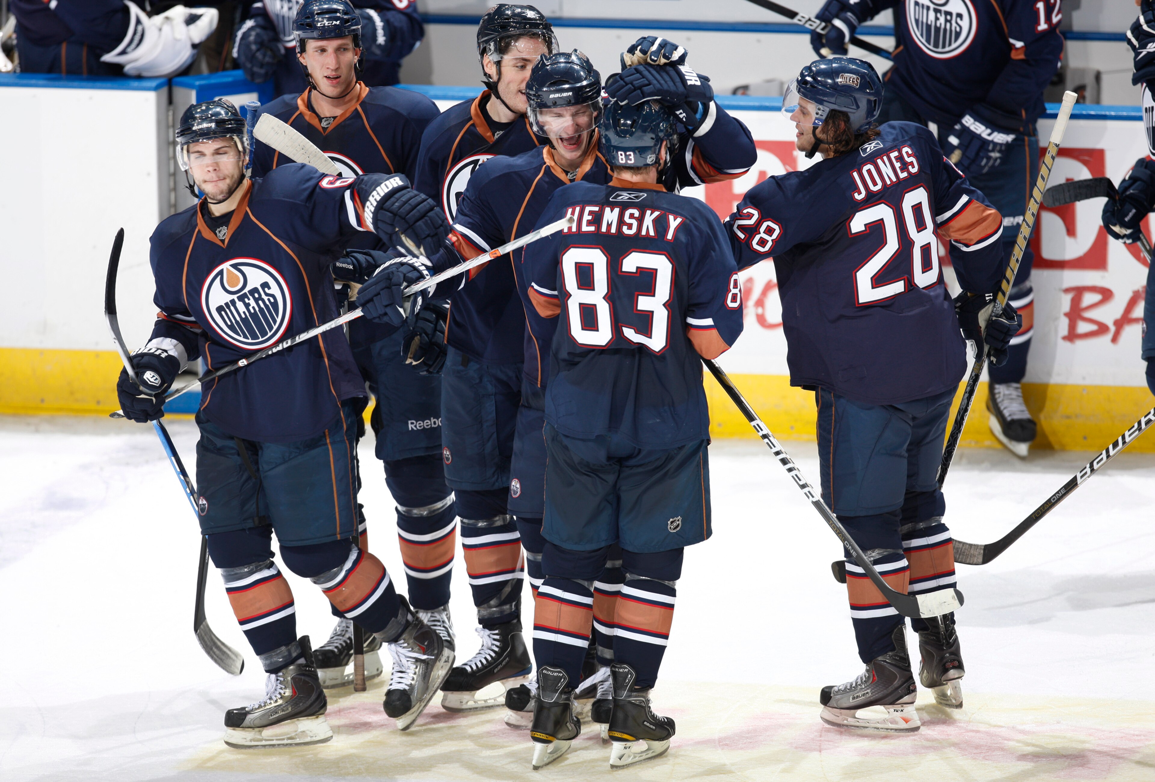 ALBERTA, CANADA - SEPTEMBER 29: Ales Hemsky #83 of the Edmonton Oilers is congratulated after scoring in a shootout by teammates Ladislav Smid #5, Gilbert Brule #67 and Ryan Jones #28 against the Phoenix Coyotes. The oilers went on to win 4-3.  on Septemb