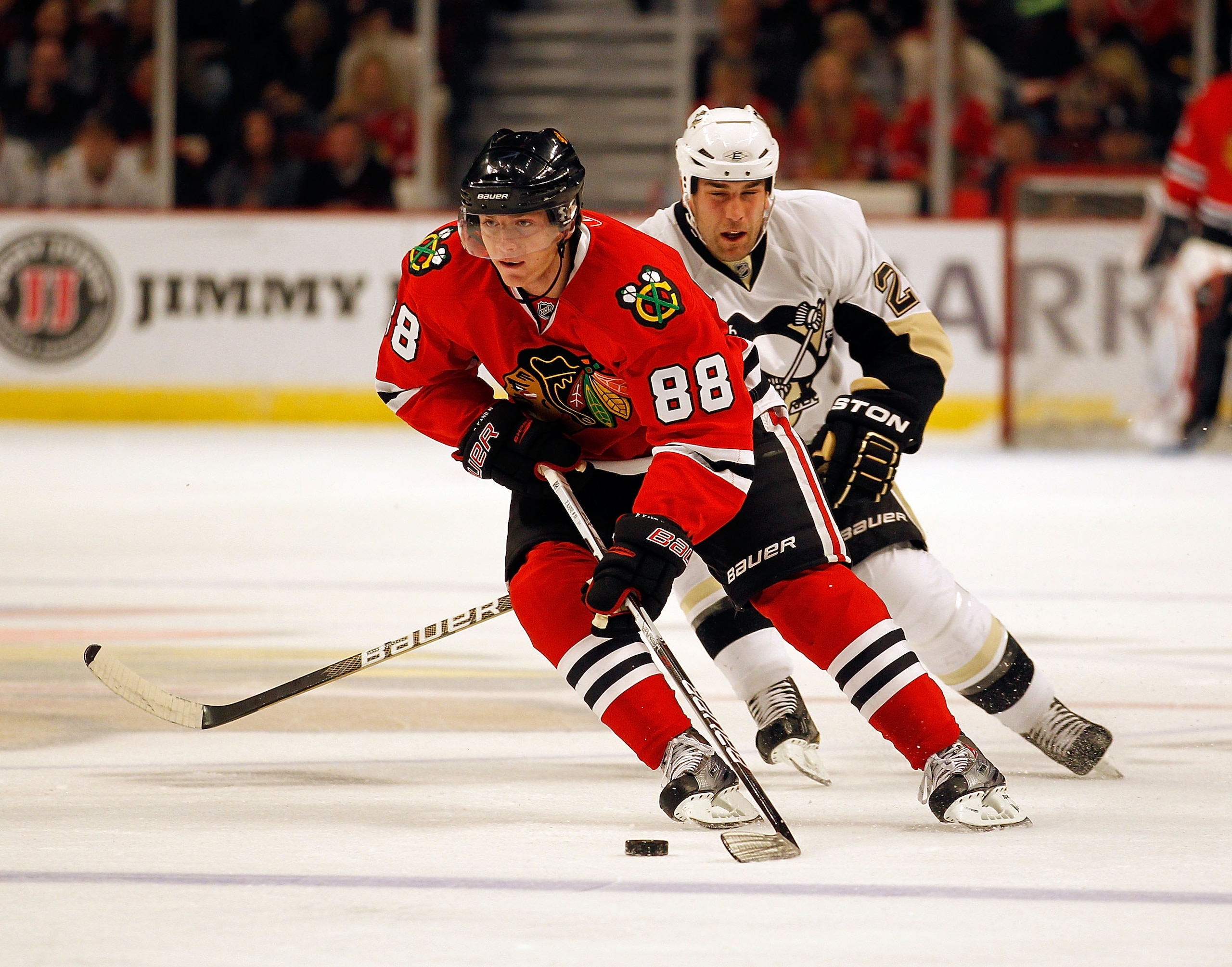 CHICAGO - OCTOBER 01: Patrick Kane #88 of the Chicago Blackhawks skates up the ice in front of Eric Godard #28 of the Pittsburgh Penguins during a pre-season game at the United Center on October 1, 2010 in Chicago, Illinois. (Photo by Jonathan Daniel/Gett