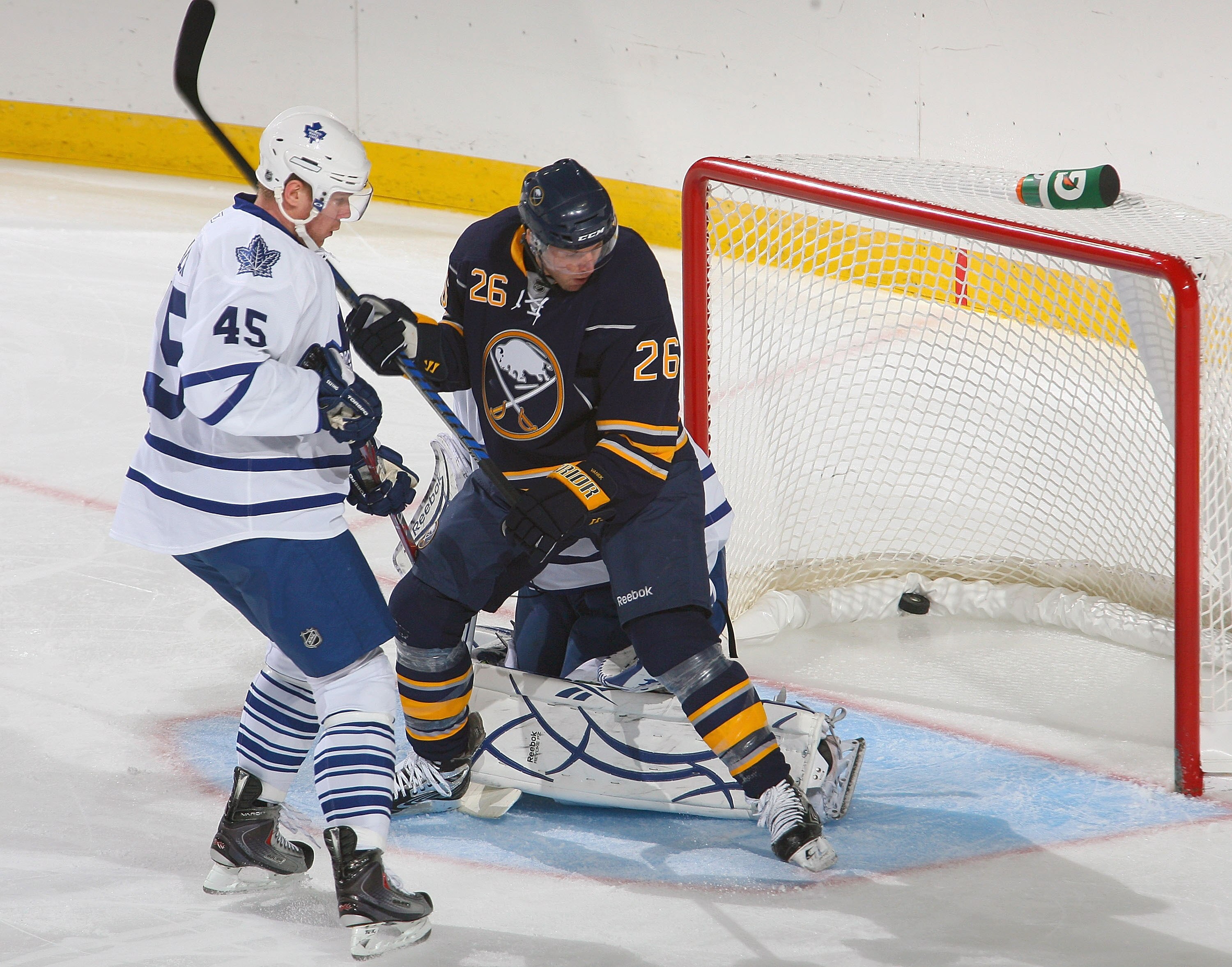 BUFFALO, NY - SEPTEMBER 25: Thomas Vanek #26 of the Buffalo Sabres screens Jonas Gustavsson #50 and Marcel Mueller #45 of the Toronto Maple Leafs as the a shot by Andrej Sekera #44 (not shown) goes in for a goal at HSBC Arena on September 25, 2010 in Buff