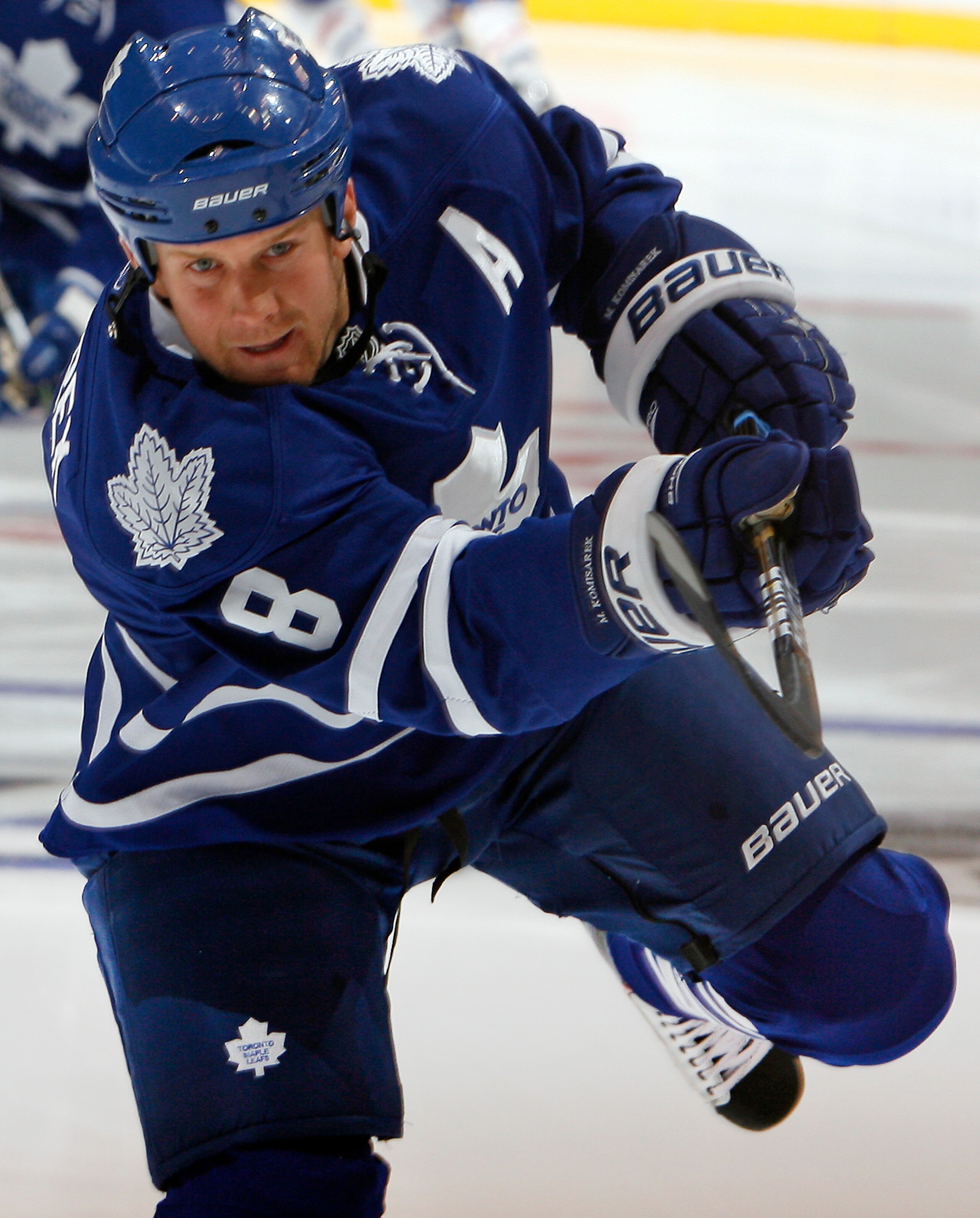 TORONTO - OCTOBER 7: Mike Komisarek #8 of the Toronto Maple Leafs shoots during warmup before playing the Montreal Canadiens during a regular season NHL game against the Toronto Maple Leafs at the Air Canada Centre October 7, 2010 in Toronto, Ontario, Can