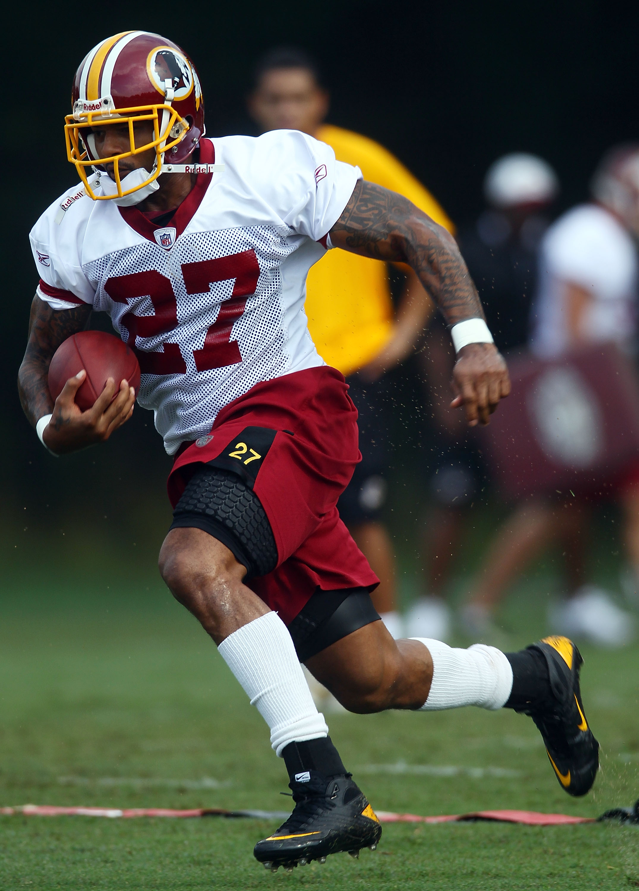 ASHBURN, VA - JULY 29:  Running back Larry Johnson #27 of the Washington Redskins carries the ball during drills on the first day of training camp July 29, 2010 in Ashburn, Virginia.  (Photo by Win McNamee/Getty Images)