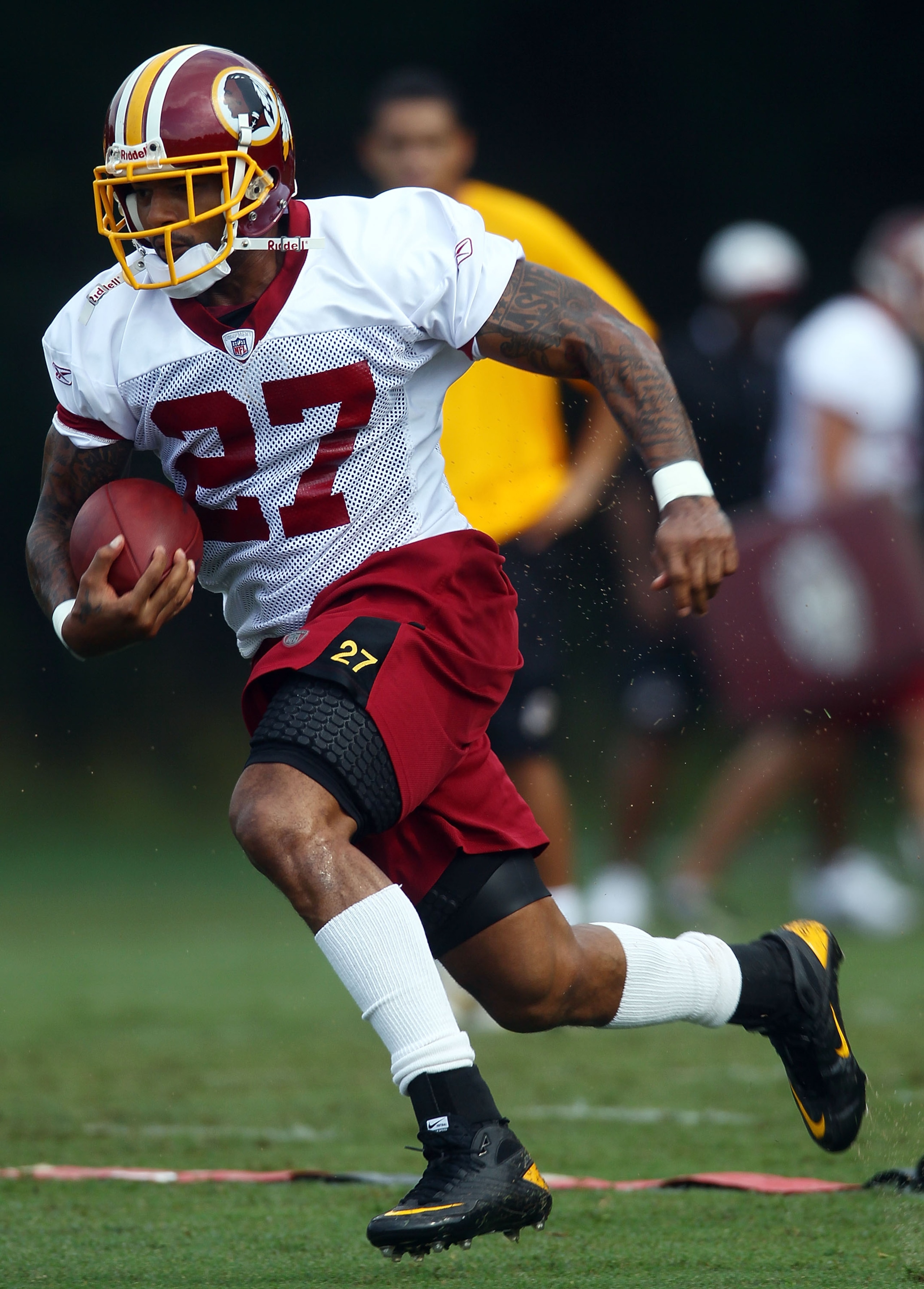ASHBURN, VA - JULY 29:  Running back Larry Johnson #27 of the Washington Redskins carries the ball during drills on the first day of training camp July 29, 2010 in Ashburn, Virginia.  (Photo by Win McNamee/Getty Images)