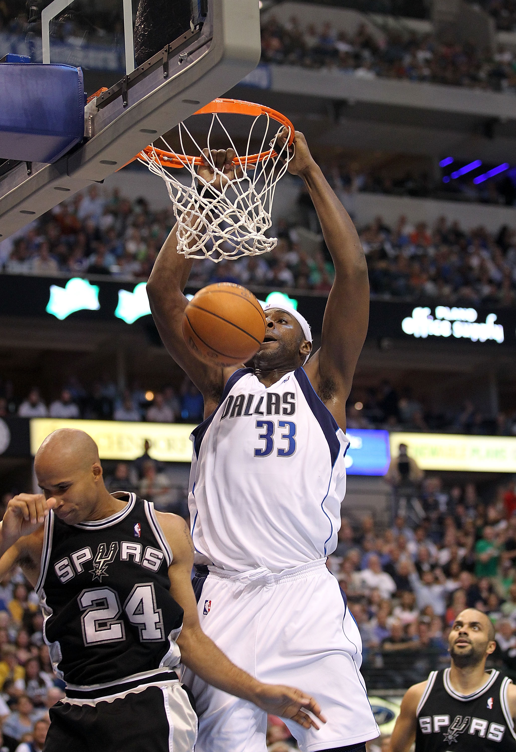 DALLAS - APRIL 21:  Center Brendan Haywood #33 fo the Dallas Mavericks makes the slam dunk in front of Richard Jefferson #24 of the San Antonio Spurs in Game Two of the Western Conference Quarterfinals during the 2010 NBA Playoffs at American Airlines Cen