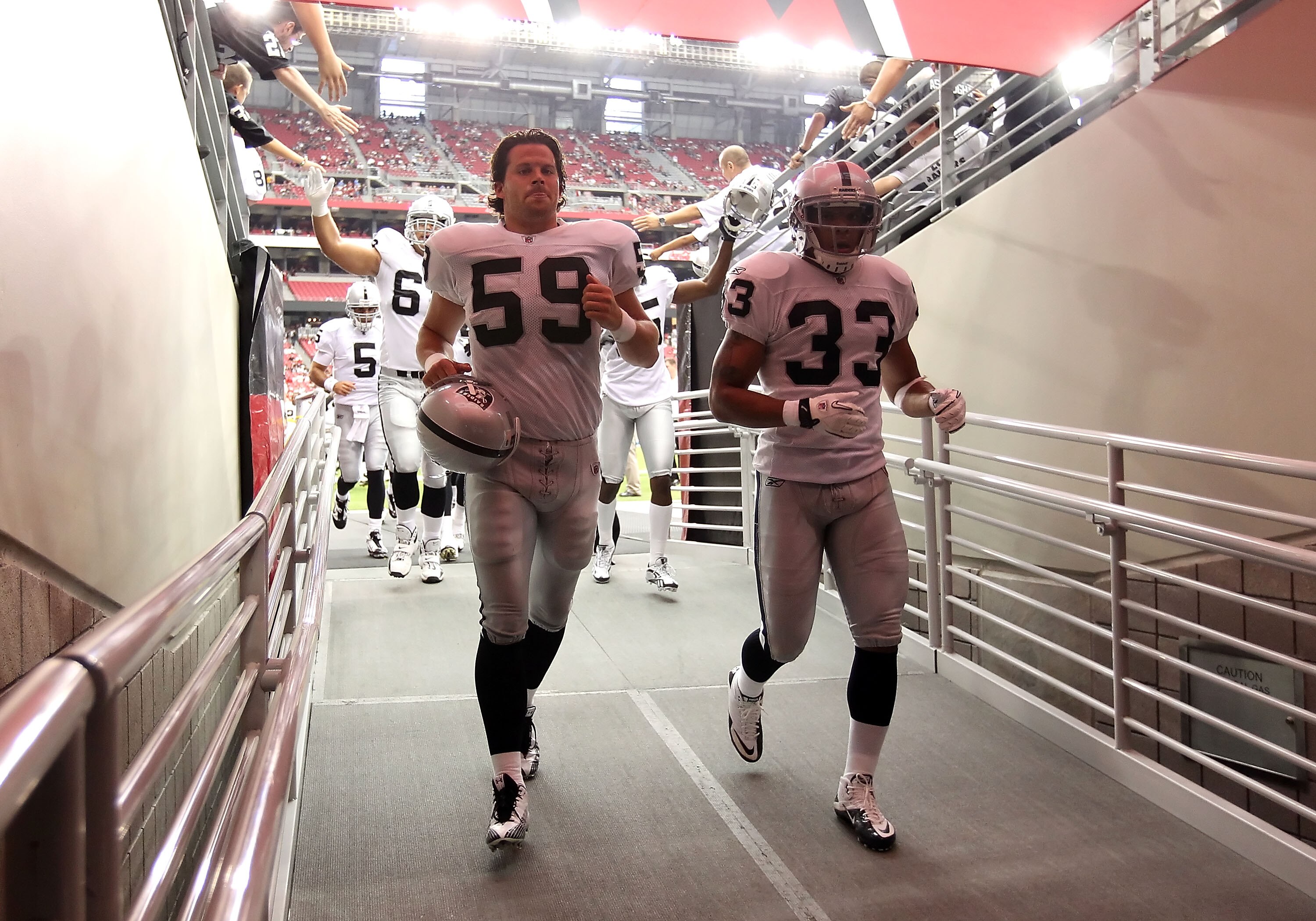 GLENDALE, AZ - SEPTEMBER 26:  (L-R) Jon Condo #59 and Tyvon Branch #33 of the Oakland Raiders before the NFL game against the Arizona Cardinals at the University of Phoenix Stadium on September 26, 2010 in Glendale, Arizona.  The Cardinals defeated the Ra