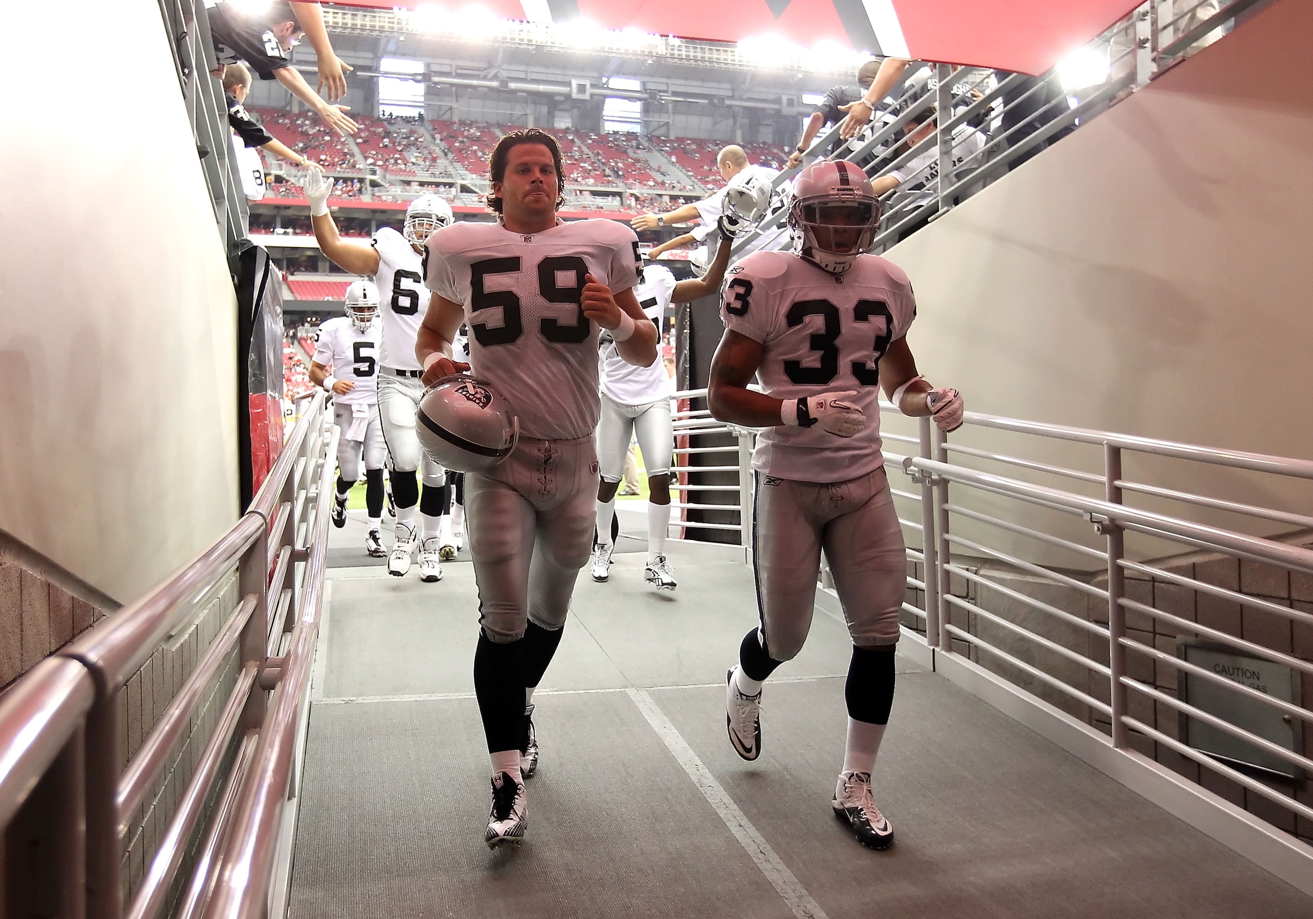 GLENDALE, AZ - SEPTEMBER 26:  (L-R) Jon Condo #59 and Tyvon Branch #33 of the Oakland Raiders before the NFL game against the Arizona Cardinals at the University of Phoenix Stadium on September 26, 2010 in Glendale, Arizona.  The Cardinals defeated the Ra