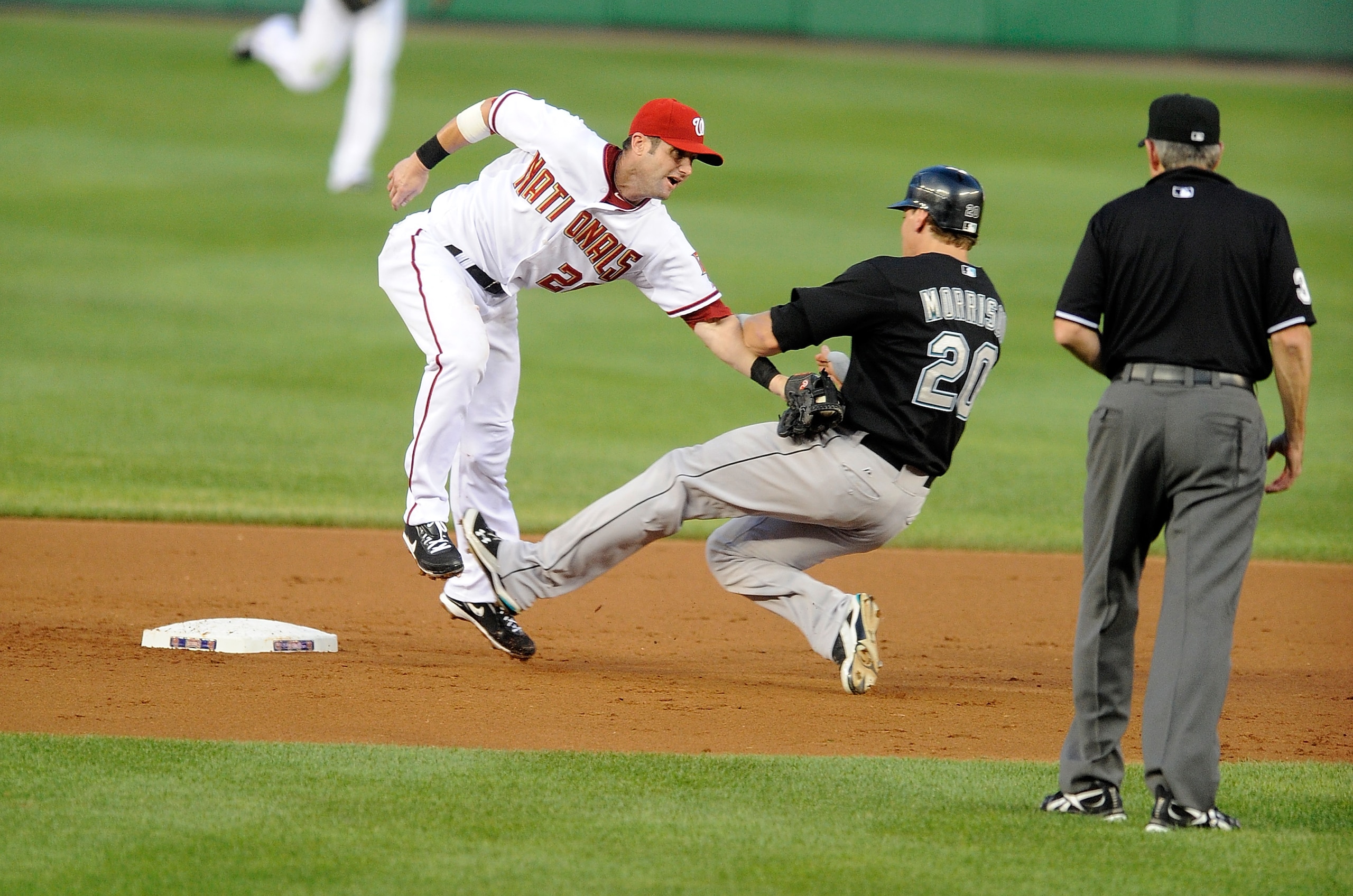 WASHINGTON - AUGUST 10:  Adam Kennedy #20 of the Washington Nationals tags out Logan Morrison #20 of the Florida Marlins at Nationals Park on August 10, 2010 in Washington, DC.  (Photo by Greg Fiume/Getty Images)