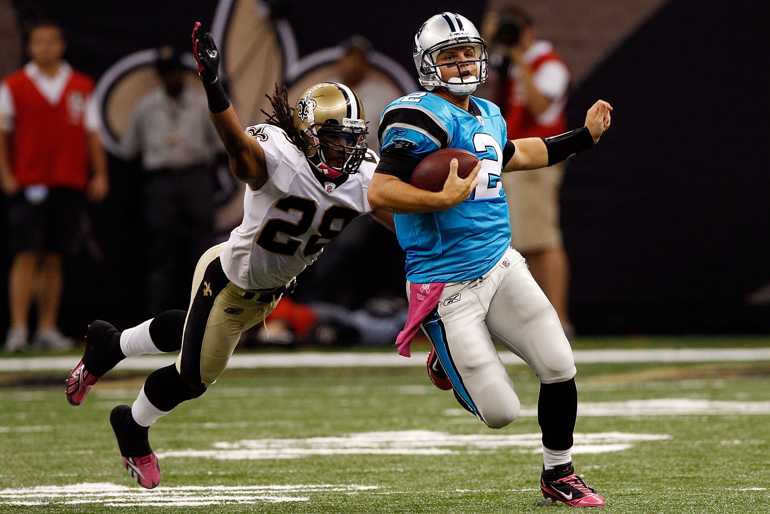 NEW ORLEANS - OCTOBER 03:  Jimmy Clausen #2 of the Carolina Panthers is tackled by Usama Young #28 of the New Orleans Saints at the Louisiana Superdome on October 3, 2010 in New Orleans, Louisiana.  (Photo by Chris Graythen/Getty Images)