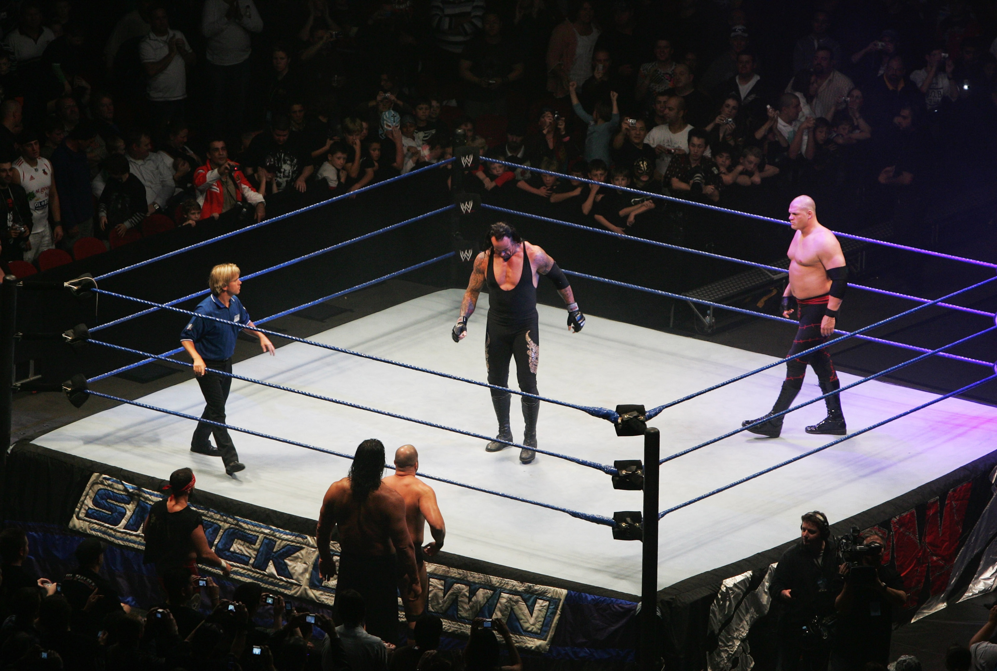 SYDNEY, AUSTRALIA - JUNE 15:  The Undertaker and ECW Champion Kane stand in the ring as the look down to Bam Neely, Chavo Guerrero, and The Great Khali during WWE Smackdown at Acer Arena on June 15, 2008 in Sydney, Australia.  (Photo by Gaye Gerard/Getty