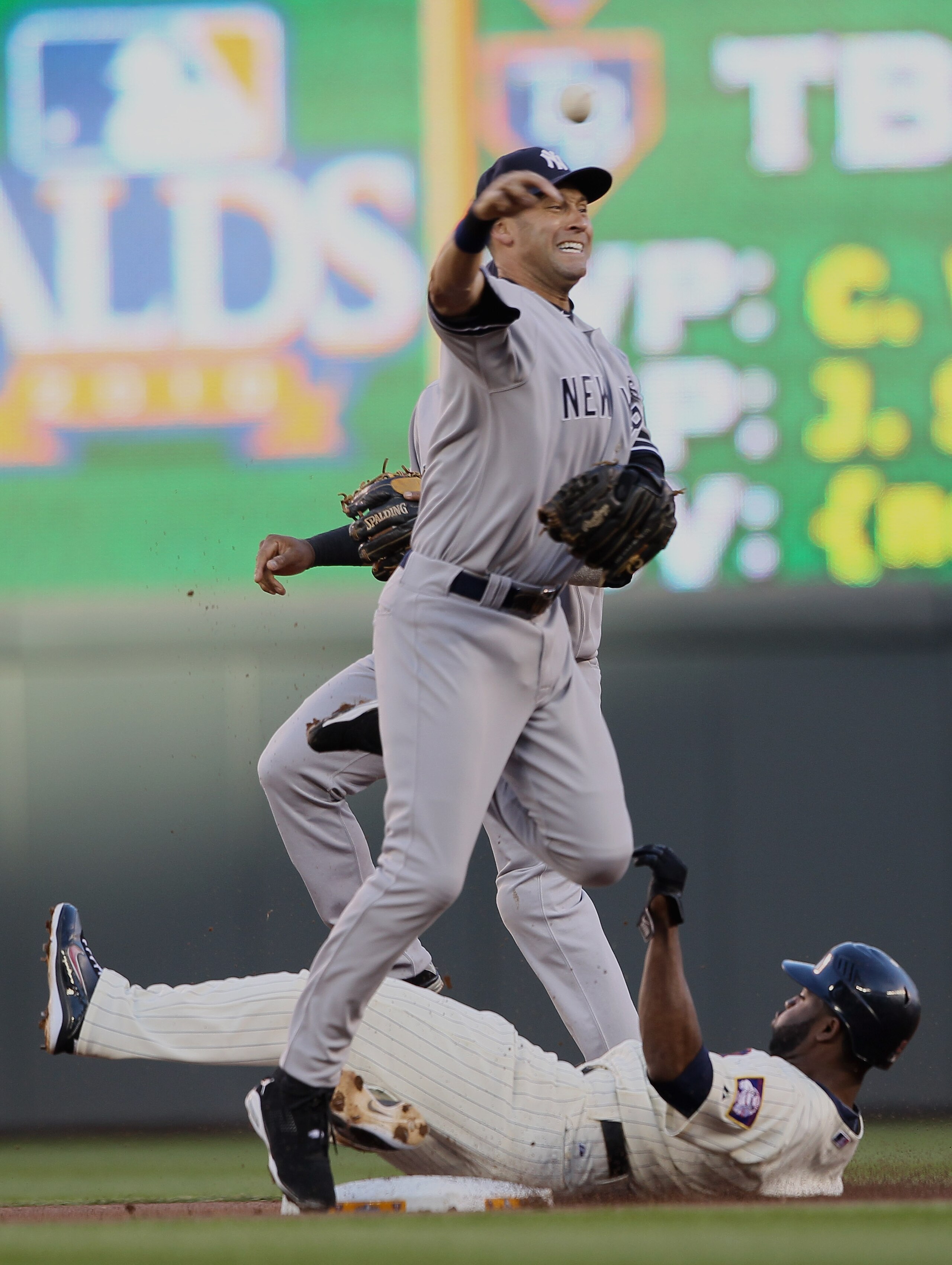 MINNEAPOLIS - OCTOBER 07:  Derek Jeter #2 of the New York Yankees sends the ball to first for the double play as Orlando Hudson #1 of the Minnesota Twins is out at second during game two of the ALDS on October 7, 2010 at Target Field in Minneapolis, Minne