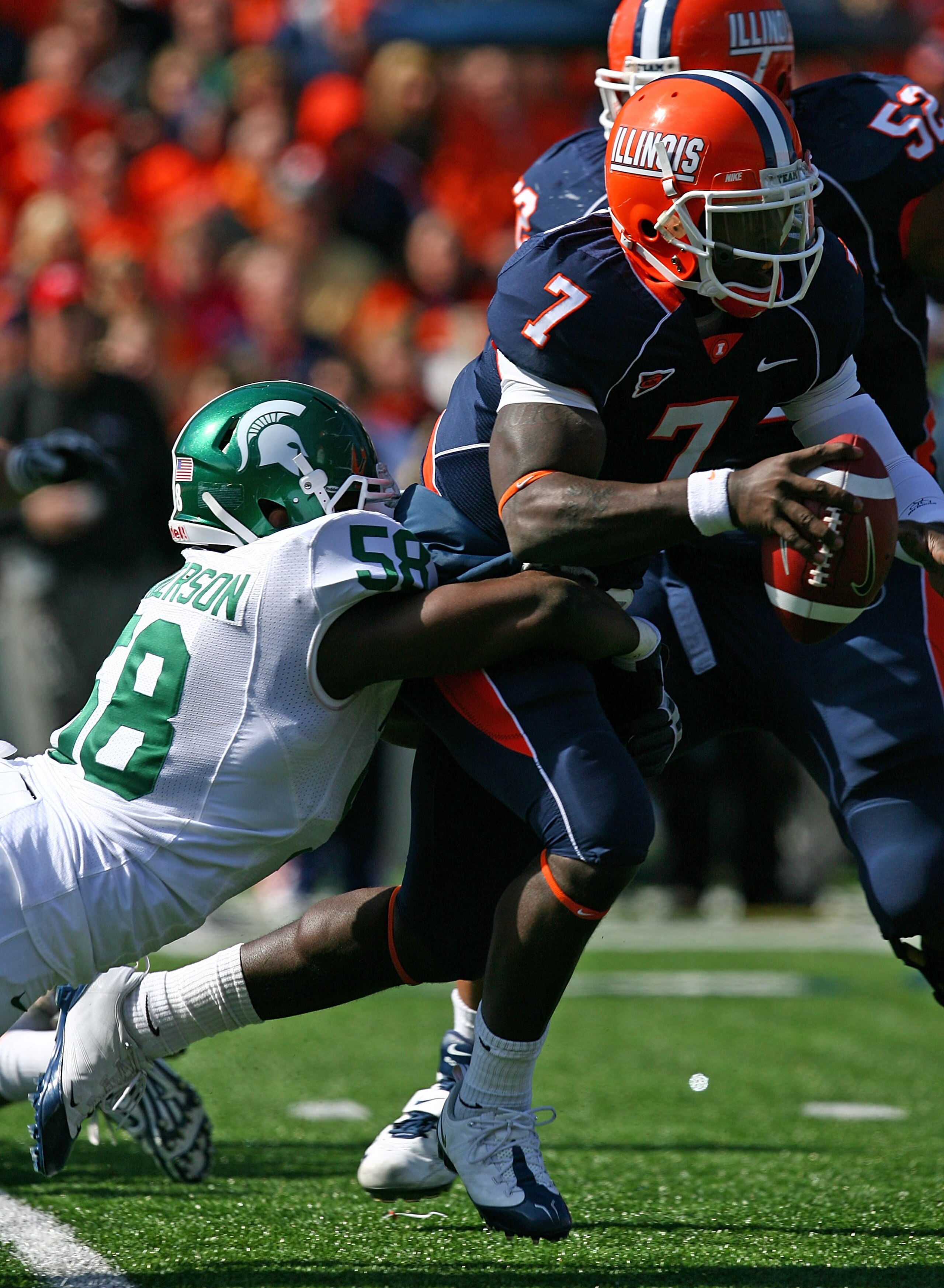 CHAMPAIGN, IL - OCTOBER 10: Juice Williams #7 of the Illinois Fighting Illini is sacked by Trevor Anderson #58 of the Michigan State Spartans on October 10, 2009 at Memorial Stadium at the University of Illinois in Champaign, Illinois. Michigan State defe