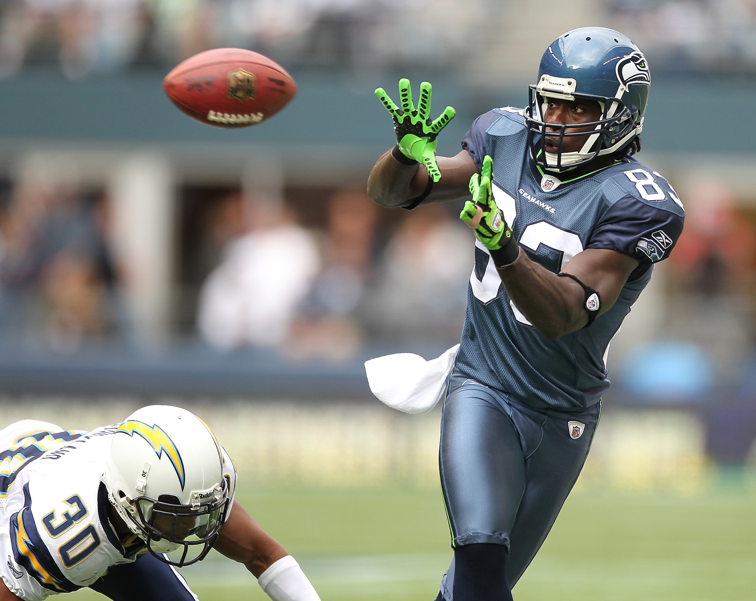 SEATTLE - SEPTEMBER 26:  Wide receiver Deion Branch #83 of the Seattle Seahawks makes a catch against Donald Strickland #30 of the San Diego Chargers at Qwest Field on September 26, 2010 in Seattle, Washington. The Seahawks defeated the Chargers 27-20. (P