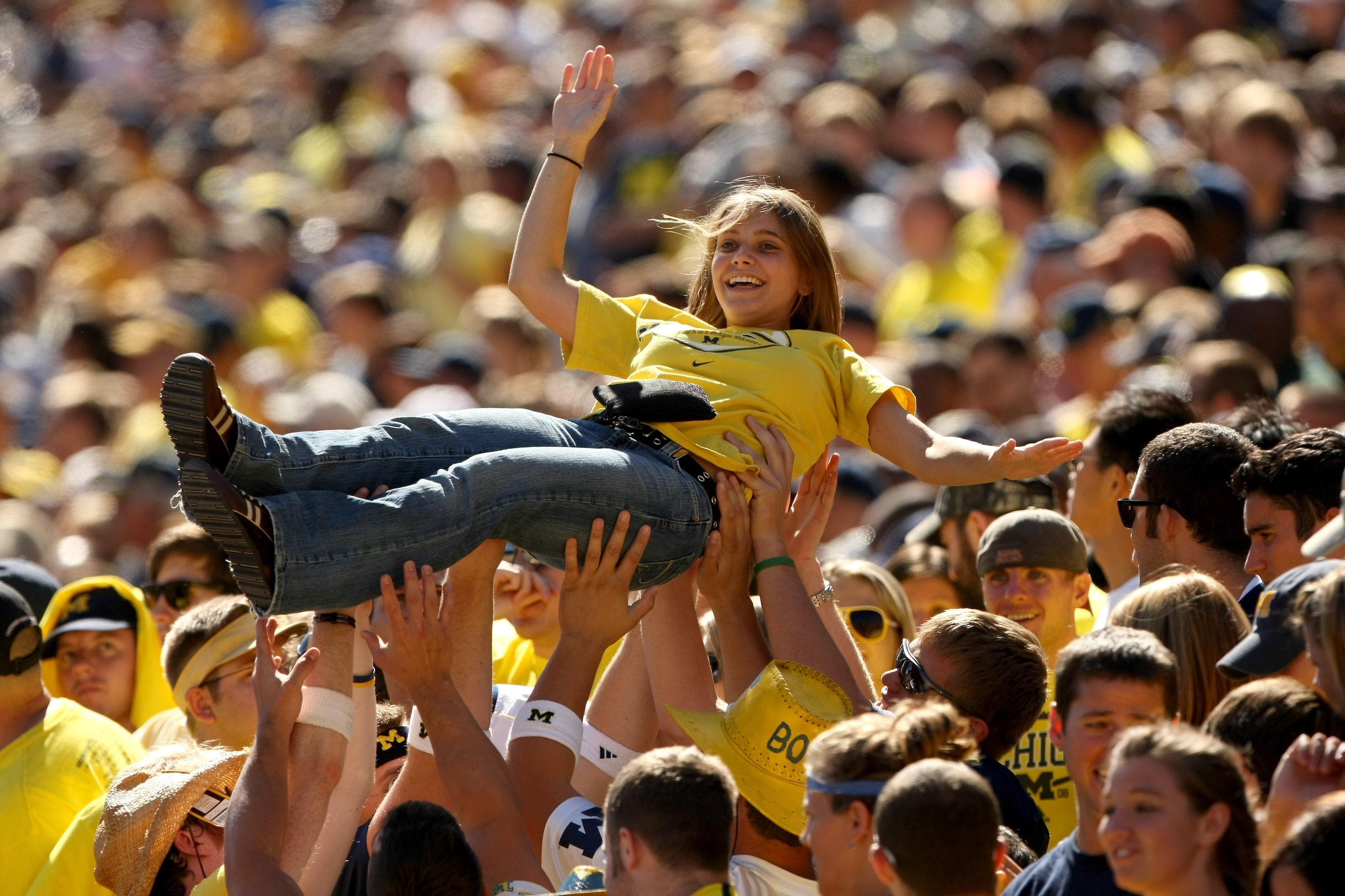 ANN ARBOR, MI - SEPTEMBER 19:  Members of the Michigan Wolverines student section lift a fan to celebrate a score against the Eastern Michigan Eagles at Michigan Stadium on September 19, 2009 in Ann Arbor, Michigan. Michigan won 45-17.  (Photo by Stephen
