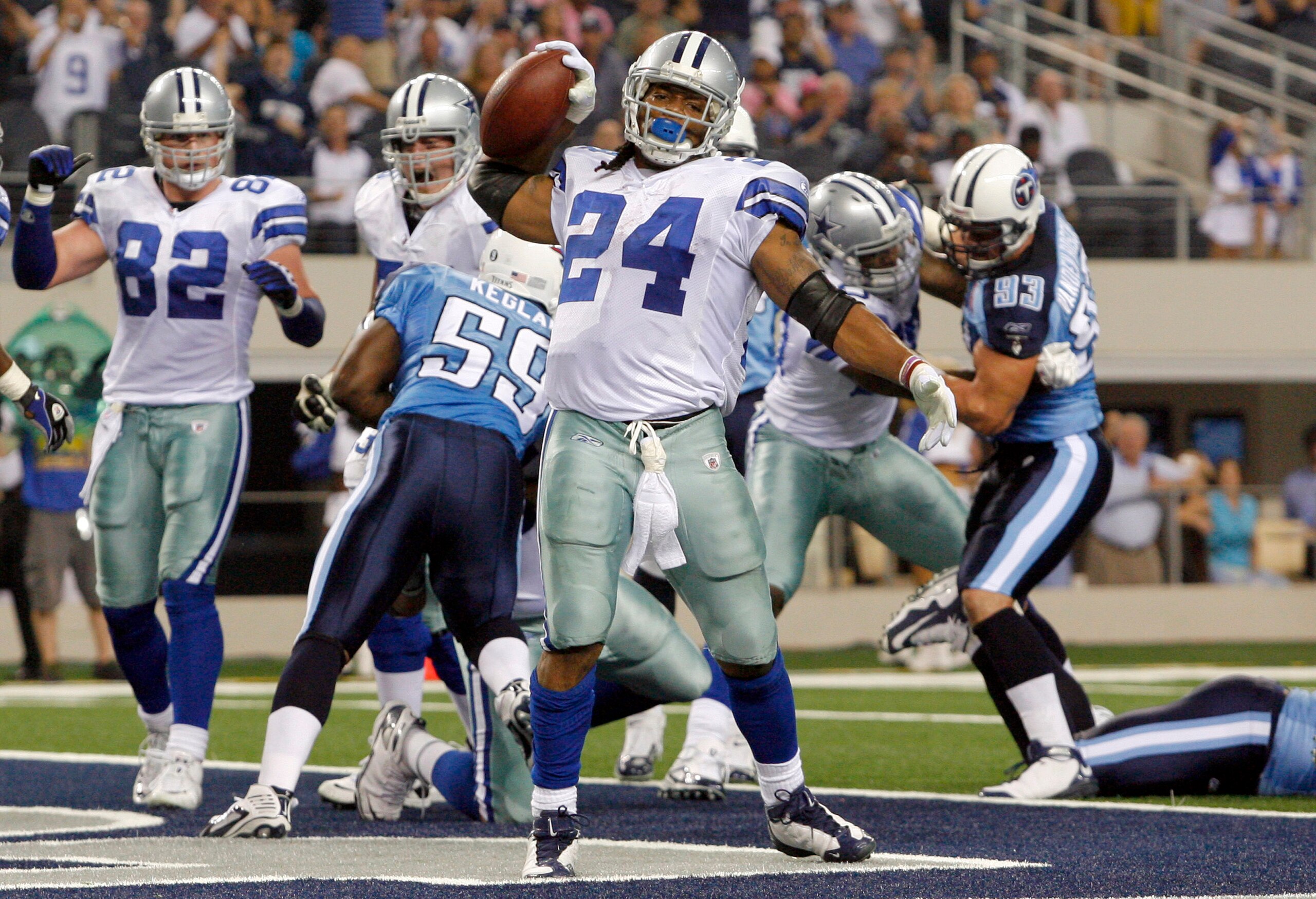 ARLINGTON, TX - AUGUST 21:  Running back Marion Barber #24 of the Dallas Cowboys celebrates in the first quarter after scoring against the Tennessee Titans during a preseason game at Cowboys Stadium on August 21, 2009 in Arlington, Texas. (Photo by Tom Pe