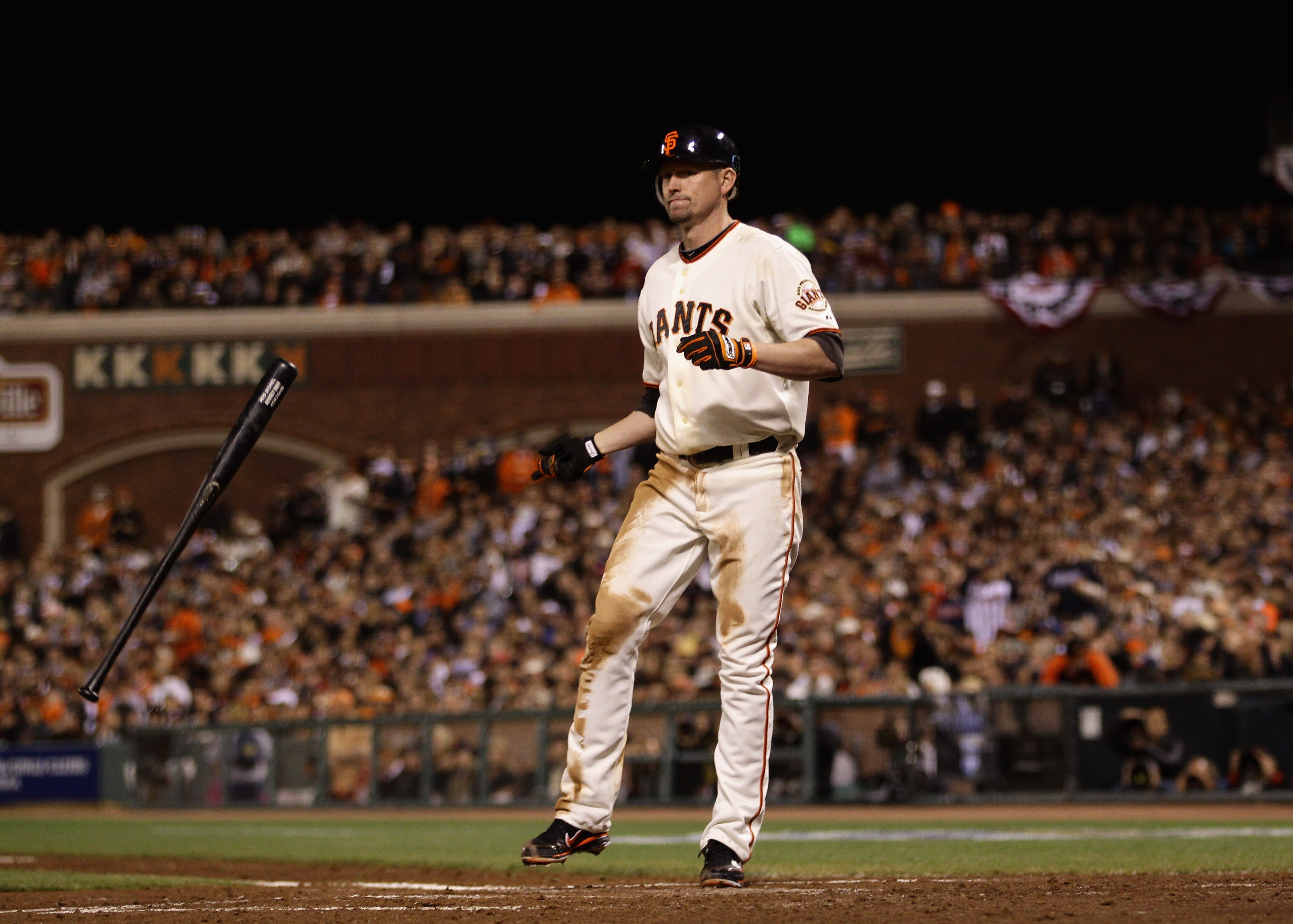 SAN FRANCISCO - OCTOBER 07:  Aubrey Huff #17 of the San Francisco Giants tosses his bat after he struck out with runners on second and third base to end the third inning of their game against the Atlanta Braves in game 1 of the NLDS at AT&T Park on Octobe