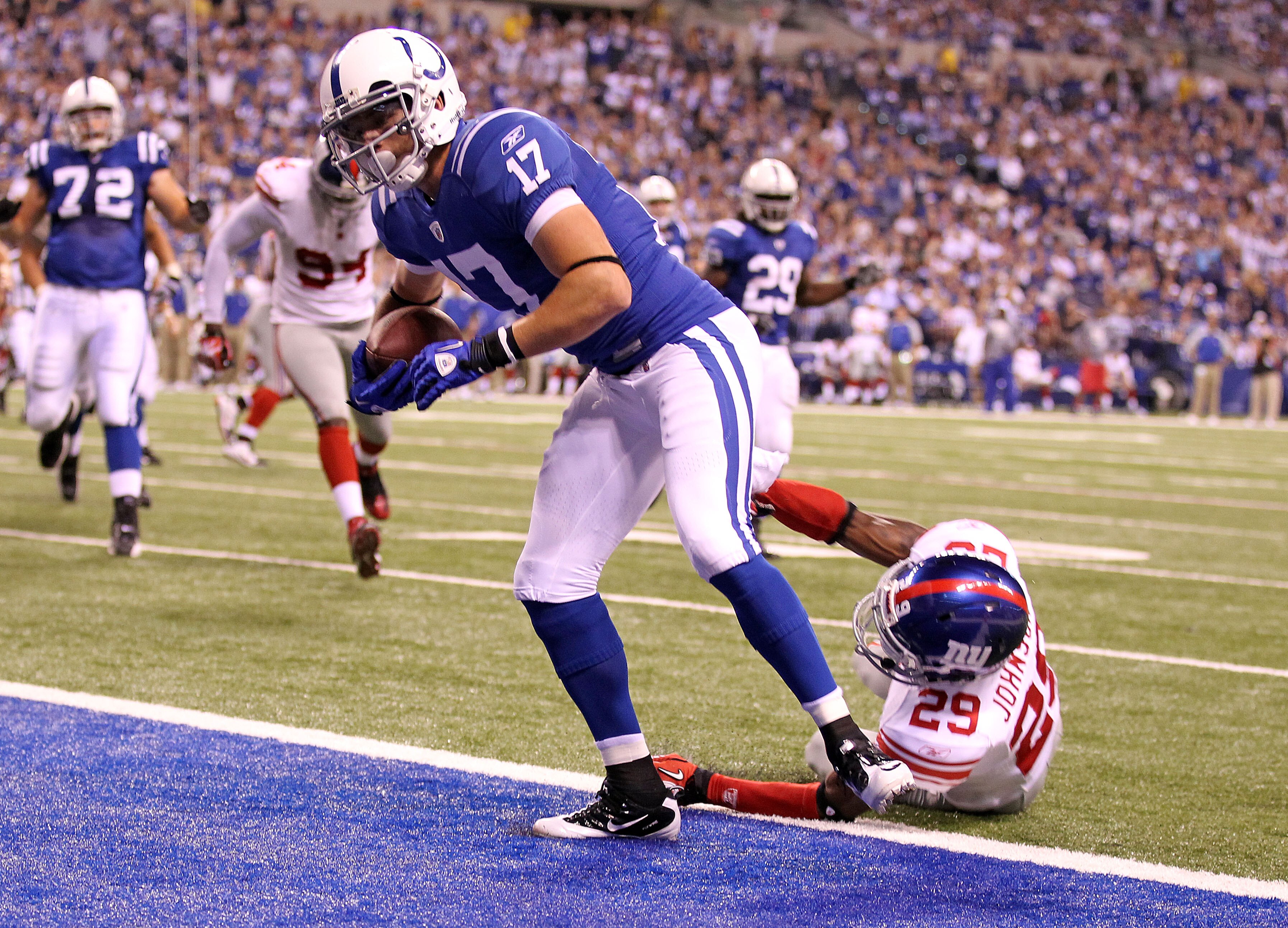 INDIANAPOLIS - SEPTEMBER 19:  Austin Collie #17  of the Indianapolis Colts scores a touchdown while defended by D.J. Johnson #29 of the New York Giants during the NFL game at Lucas Oil Stadium on September 19, 2010 in Indianapolis, Indiana.  (Photo by And