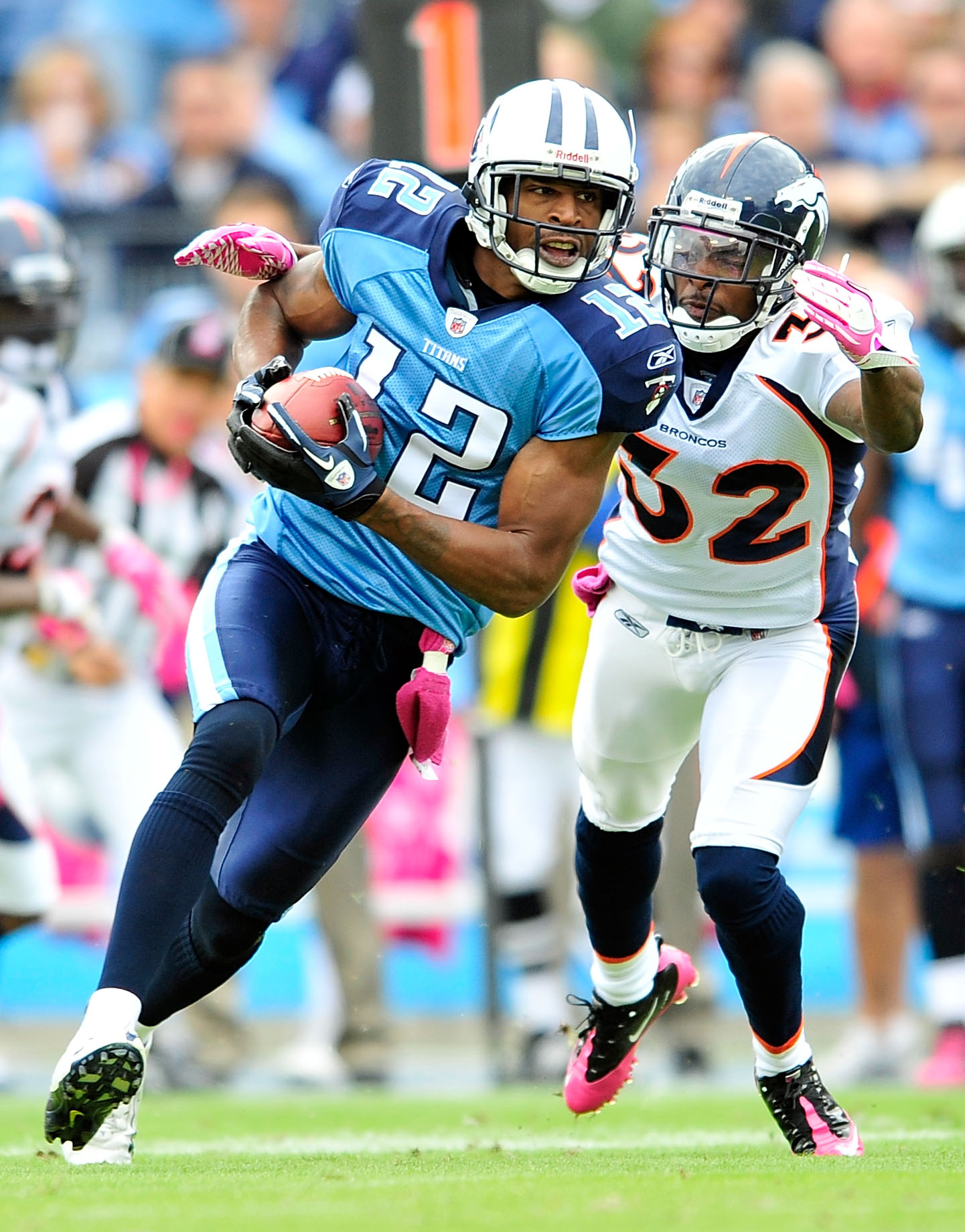 NASHVILLE, TN - OCTOBER 03:  Justin Gage #12 of the Tennessee Titans makes a catch under pressure from Perrish Cox #32 of the Denver Broncos during the first half at LP Field on October 3, 2010 in Nashville, Tennessee.  (Photo by Grant Halverson/Getty Ima