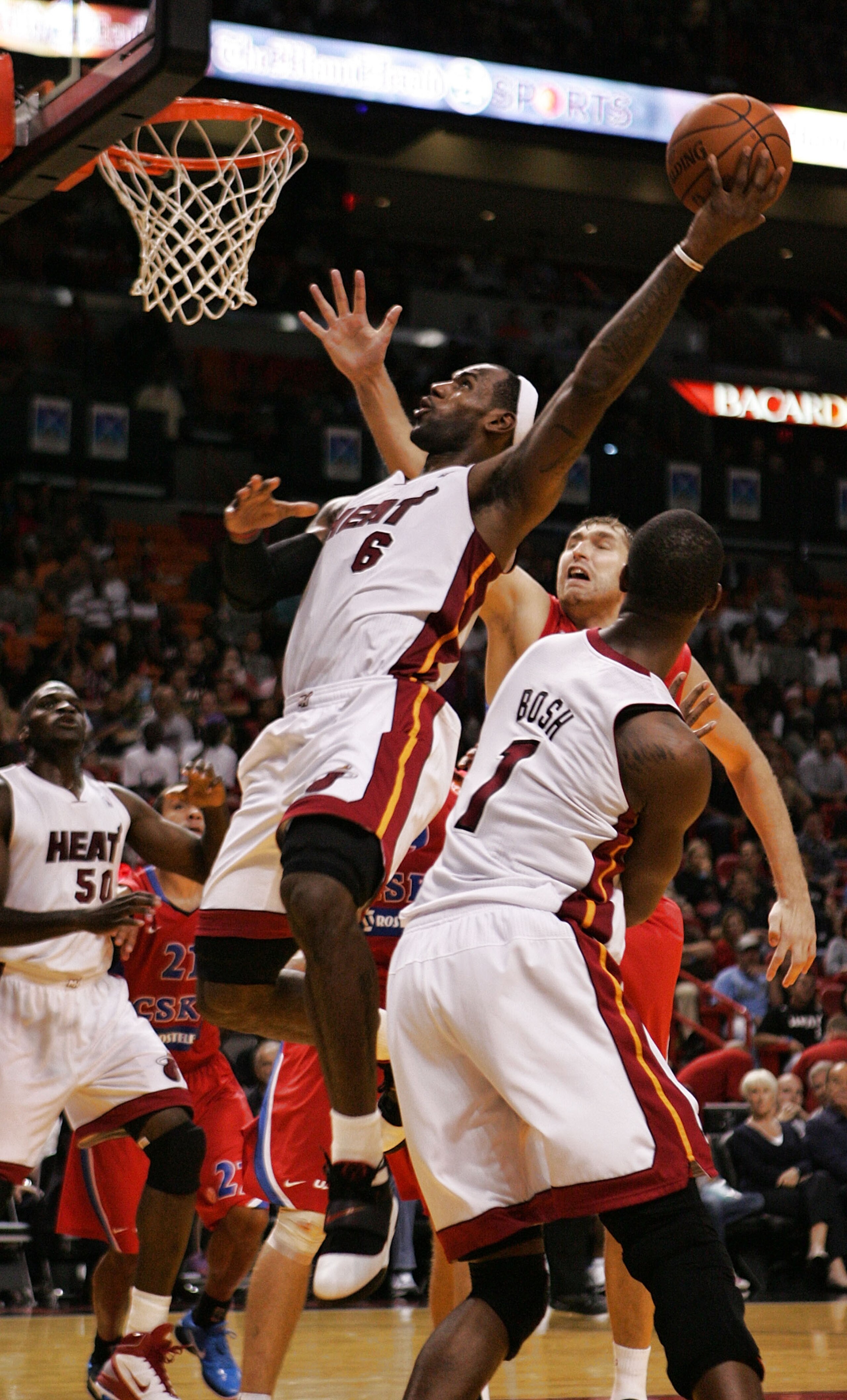 MIAMI - OCTOBER 12:  Forward LeBron James #6 scors and Chris Bosh #1 looks on of the Miami Heat CSKA Moskow on October 12, 2010 in Miami, Florida.  NOTE TO USER: User expressly acknowledges and agrees that, by downloading and or using this photograph, Use