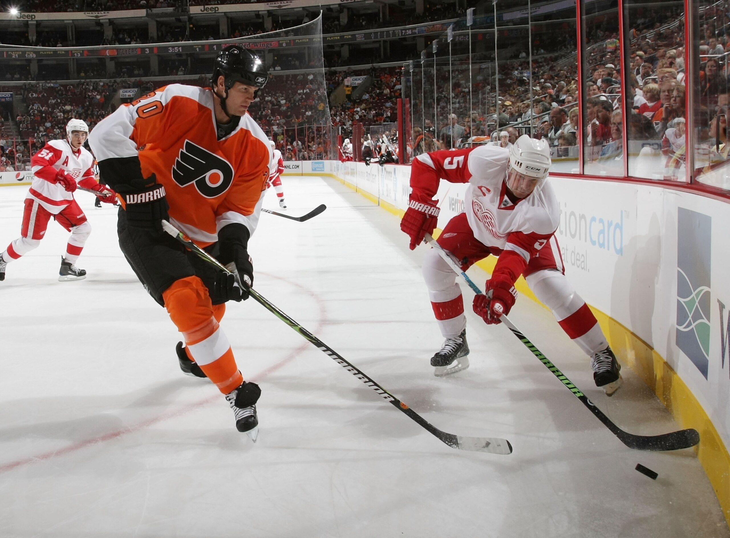 PHILADELPHIA - SEPTEMBER 22: Nicklas Lidstrom #5 of the Detroit Red Wings shoots the puck past Chris Pronger #20 of the Philadelphia Flyers during preseason action at the Wachovia Center on September 22, 2009 in Philadelphia, Pennsylvania.  (Photo by Bruc