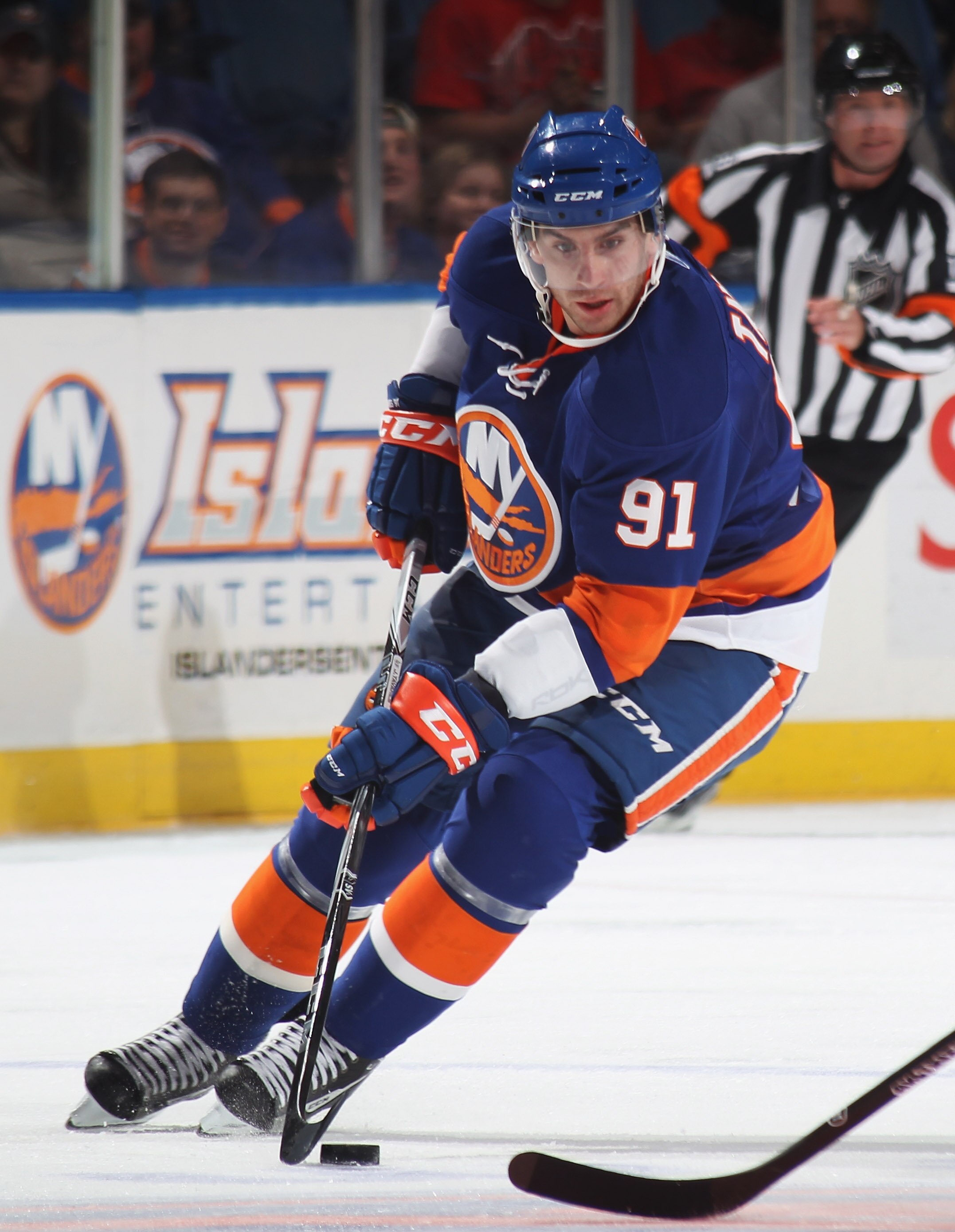UNIONDALE, NY - OCTOBER 02:  John Tavares #91 of the New York Islanders skates against the New Jersey Devils at the Nassau Veterans Memorial Coliseum on October 2, 2010 in Uniondale, New York. The Islanders defeated the Devils 2-1.  (Photo by Bruce Bennet