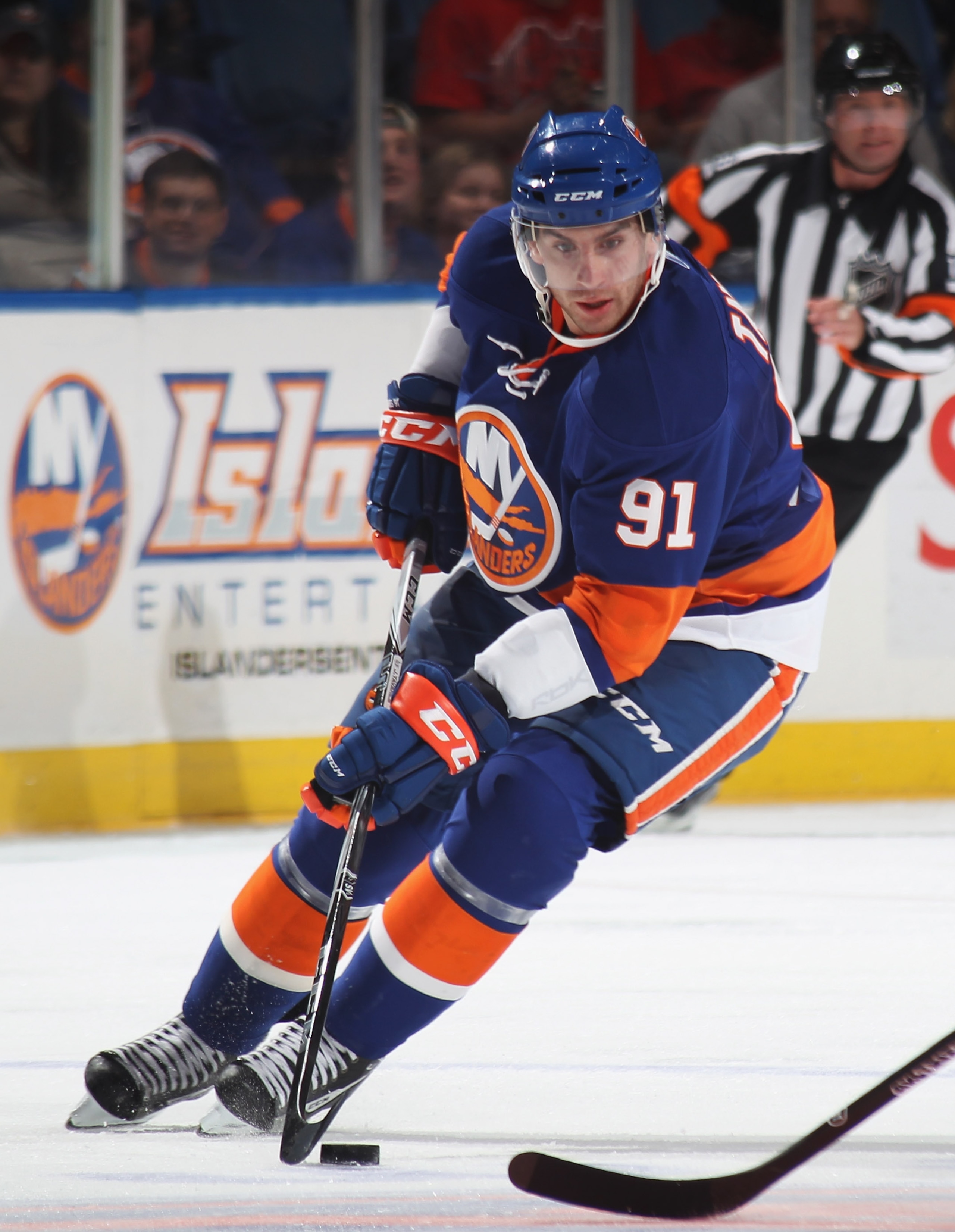 UNIONDALE, NY - OCTOBER 02:  John Tavares #91 of the New York Islanders skates against the New Jersey Devils at the Nassau Veterans Memorial Coliseum on October 2, 2010 in Uniondale, New York. The Islanders defeated the Devils 2-1.  (Photo by Bruce Bennet