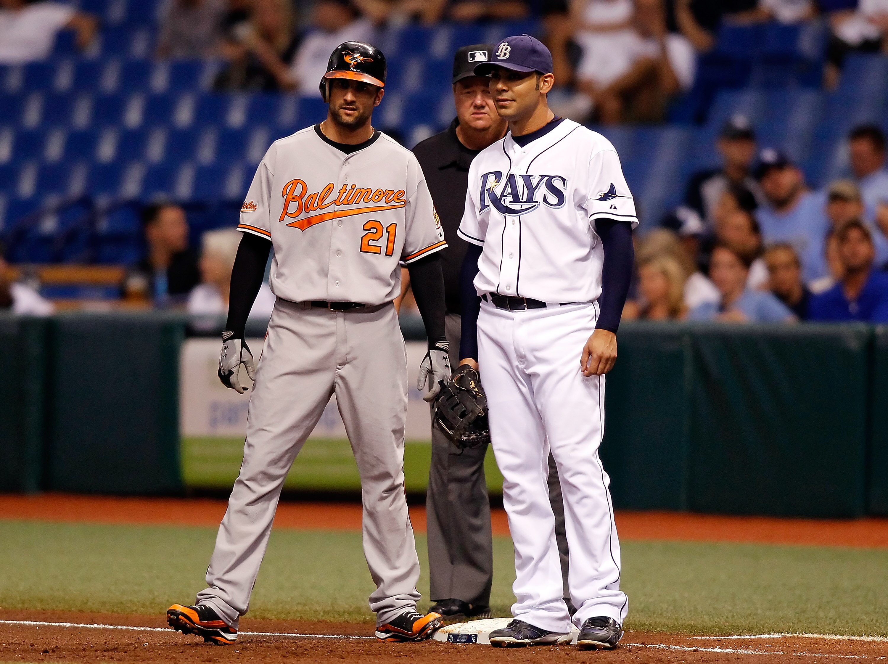 ST. PETERSBURG - SEPTEMBER 27:  Nick Markakis #21 of the Baltimore Orioles talks with first baseman Carlos Pena #23 of the Tampa Bay Rays during the first inning at Tropicana Field on September 27, 2010 in St. Petersburg, Florida.  (Photo by J. Meric/Gett
