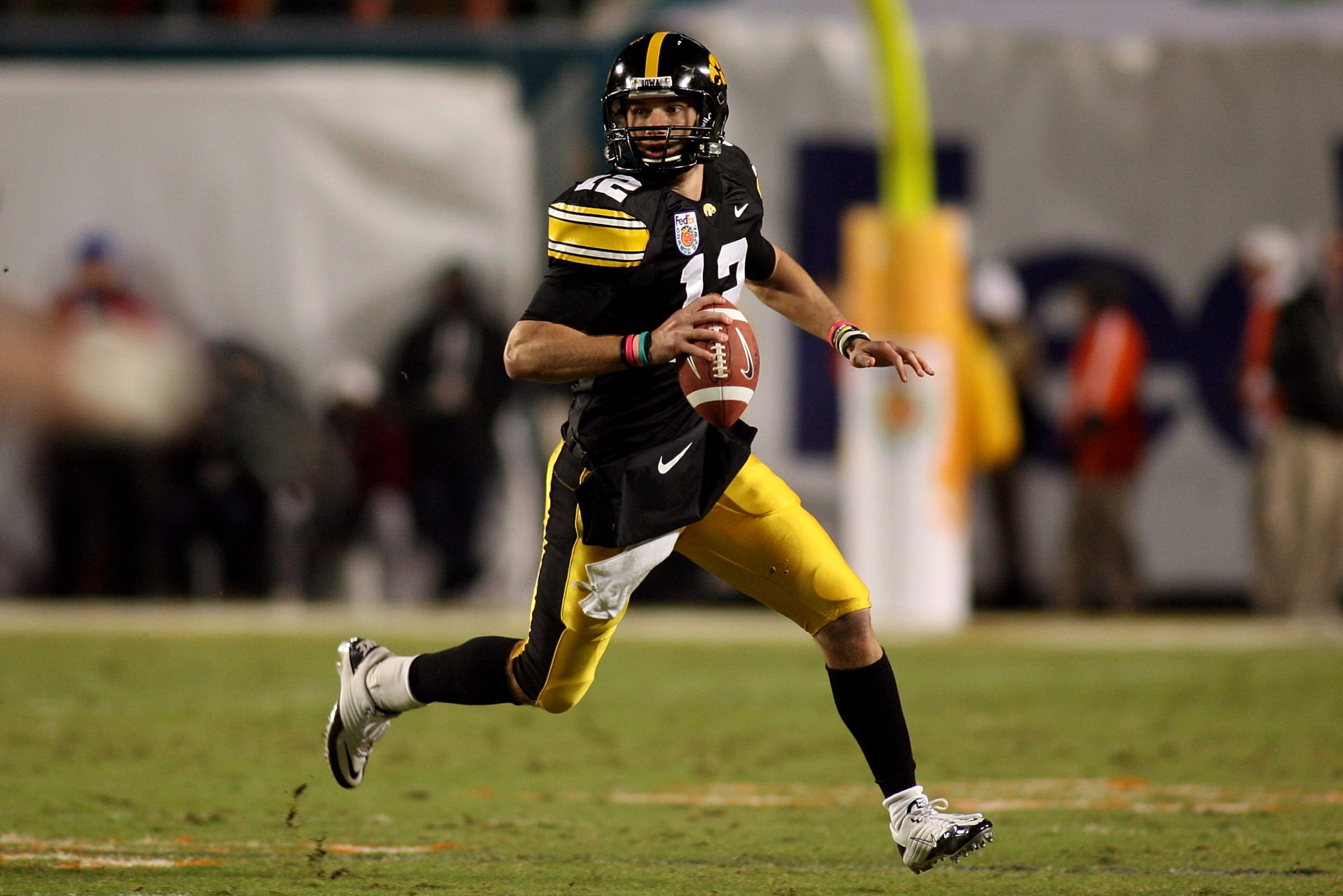 MIAMI GARDENS, FL - JANUARY 05:  Ricky Stanzi #12 of the Iowa Hawkeyes rolls out to pass against the Georgia Tech Yellow Jackets during the FedEx Orange Bowl at Land Shark Stadium on January 5, 2010 in Miami Gardens, Florida.  (Photo by Marc Serota/Getty
