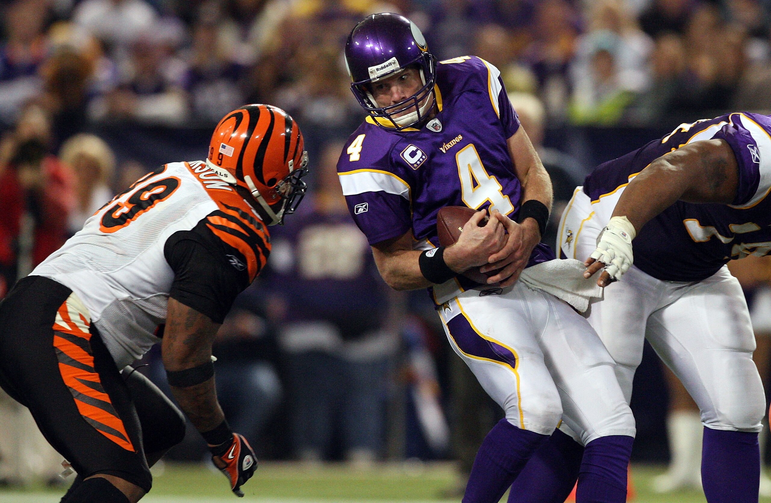MINNEAPOLIS, MN - DECEMBER 13:  Brett Favre #4 of the Minnesota Vikings is sacked by Tank Johnson #99 of the Cincinnati Bengals on December 13, 2009 at Hubert H. Humphrey Metrodome in Minneapolis, Minnesota. The Vikings defeated the Bengals 30-10.  (Photo