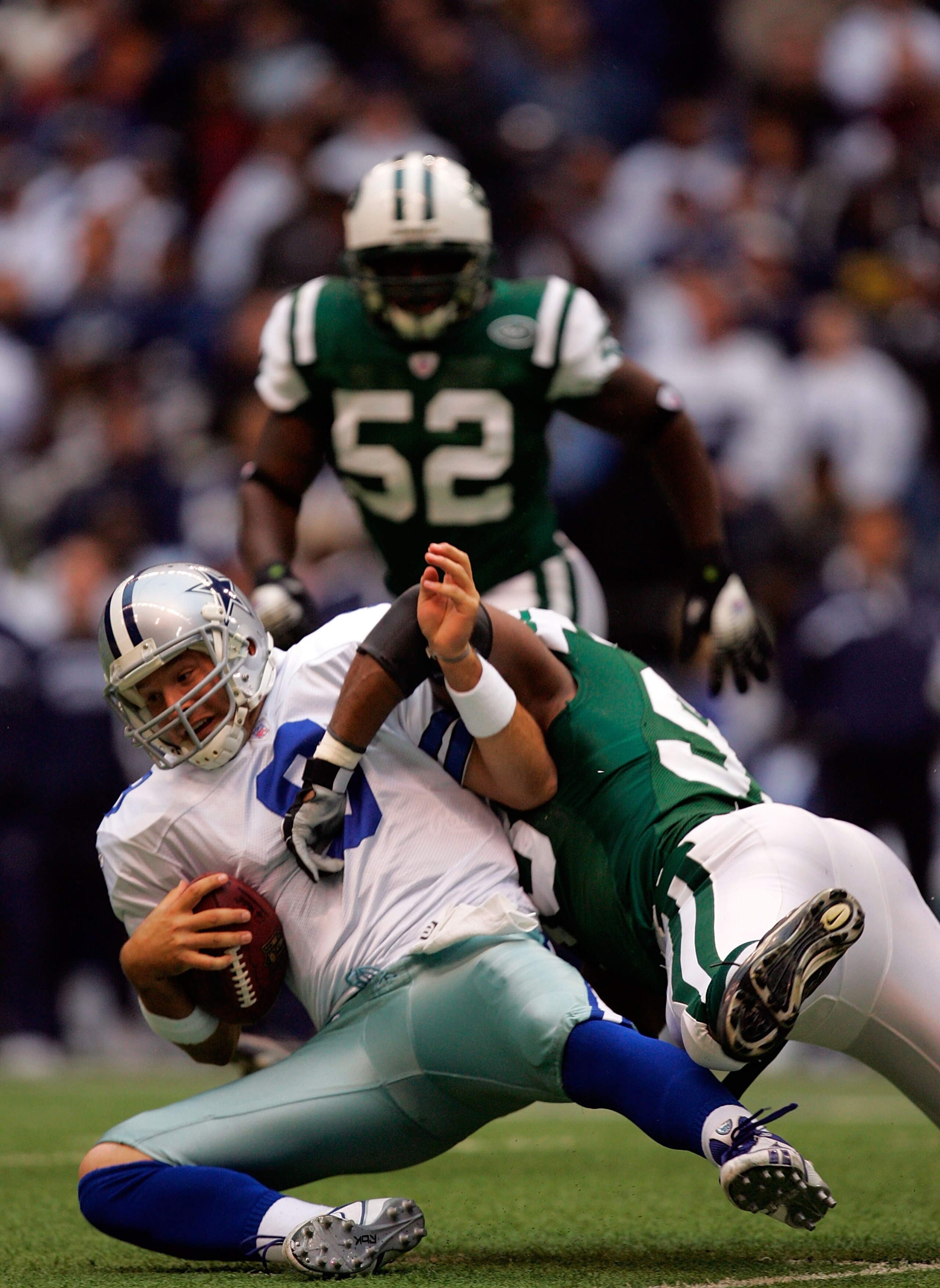DALLAS - NOVEMBER 22:  Quarterback Tony Romo #9 of the Dallas Cowboys is sacked by Kenyon Coleman #93 of the New York Jets in the first quarter at Texas Stadium on November 22, 2007 in Irving, Texas  (Photo by Ronald Martinez/Getty Images)