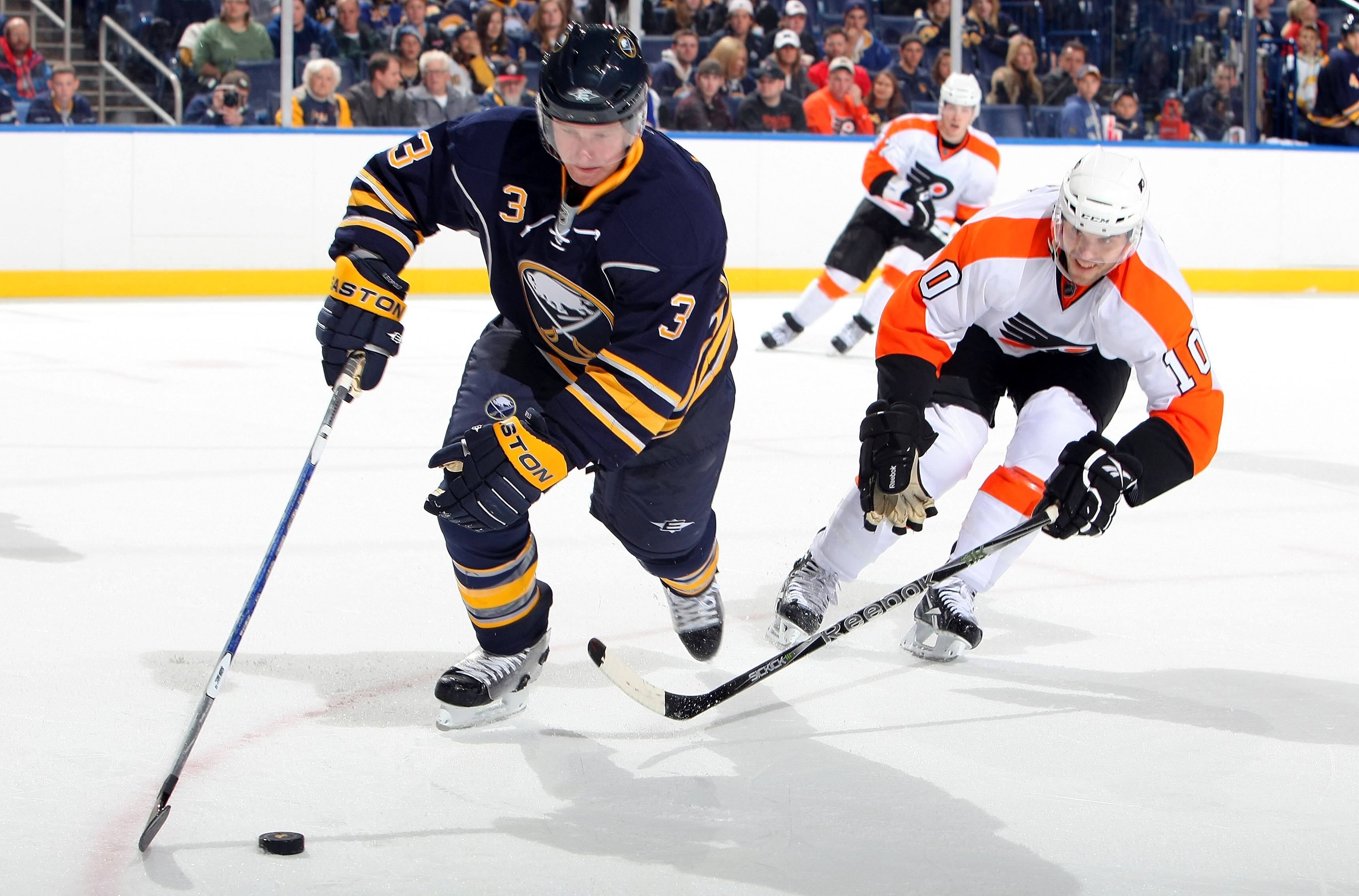 BUFFALO - OCTOBER 3:  David Laliberte #10 of the Philadelphia Flyers battles for a loose puck with Jordan Leopold #3 of the Buffalo Sabres during their NHL preseason game at HSBC Arena October 3, 2010 in Buffalo, New York.(Photo By Dave Sandford/Getty Ima