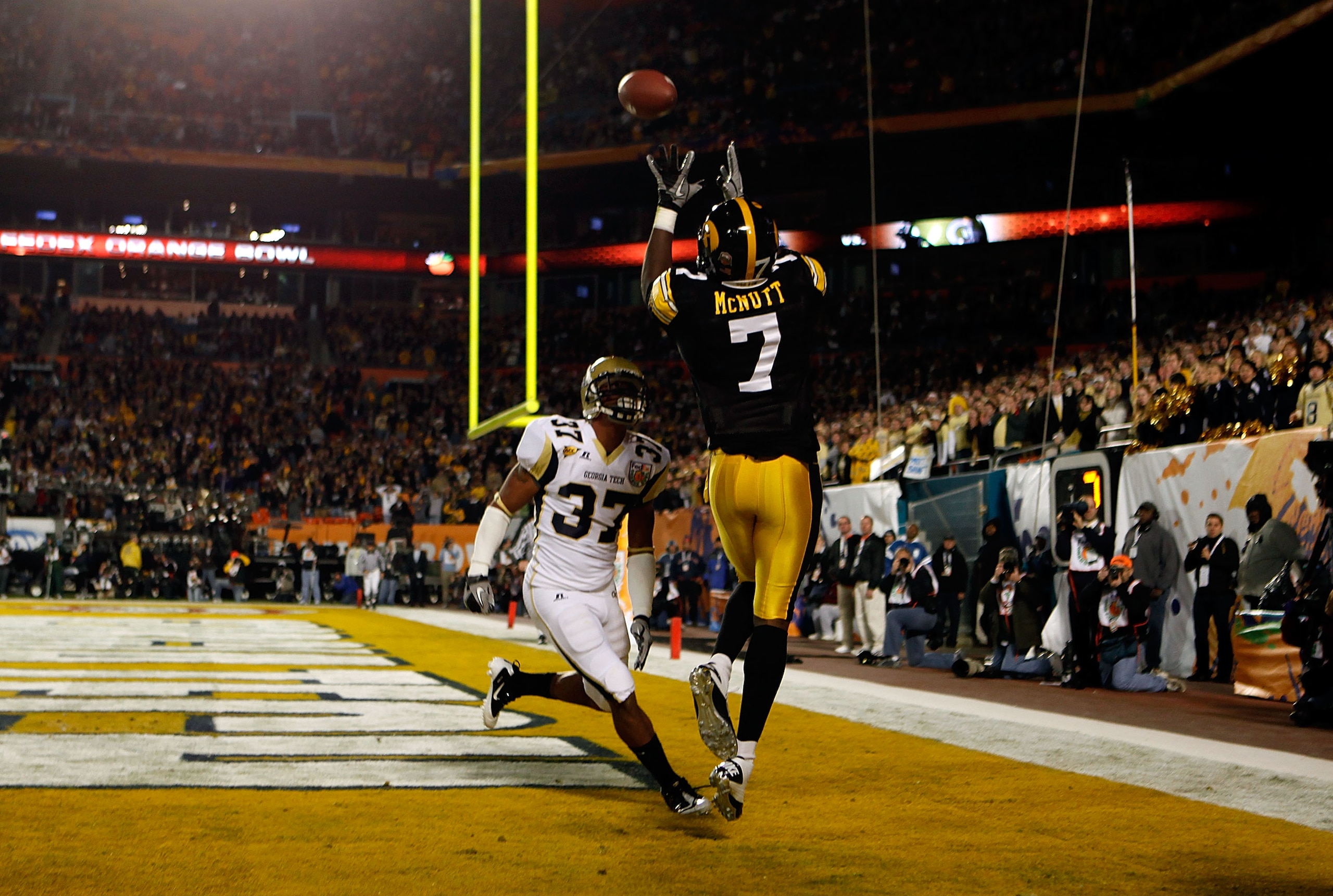 MIAMI GARDENS, FL - JANUARY 05:  Marvin McNutt #7 of the Iowa Hawkeyes catches a 3-yard touchdown pass in the first quarter against Jerrard Tarrant #37 of the Georgia Tech Yellow Jackets during the FedEx Orange Bowl at Land Shark Stadium on January 5, 201
