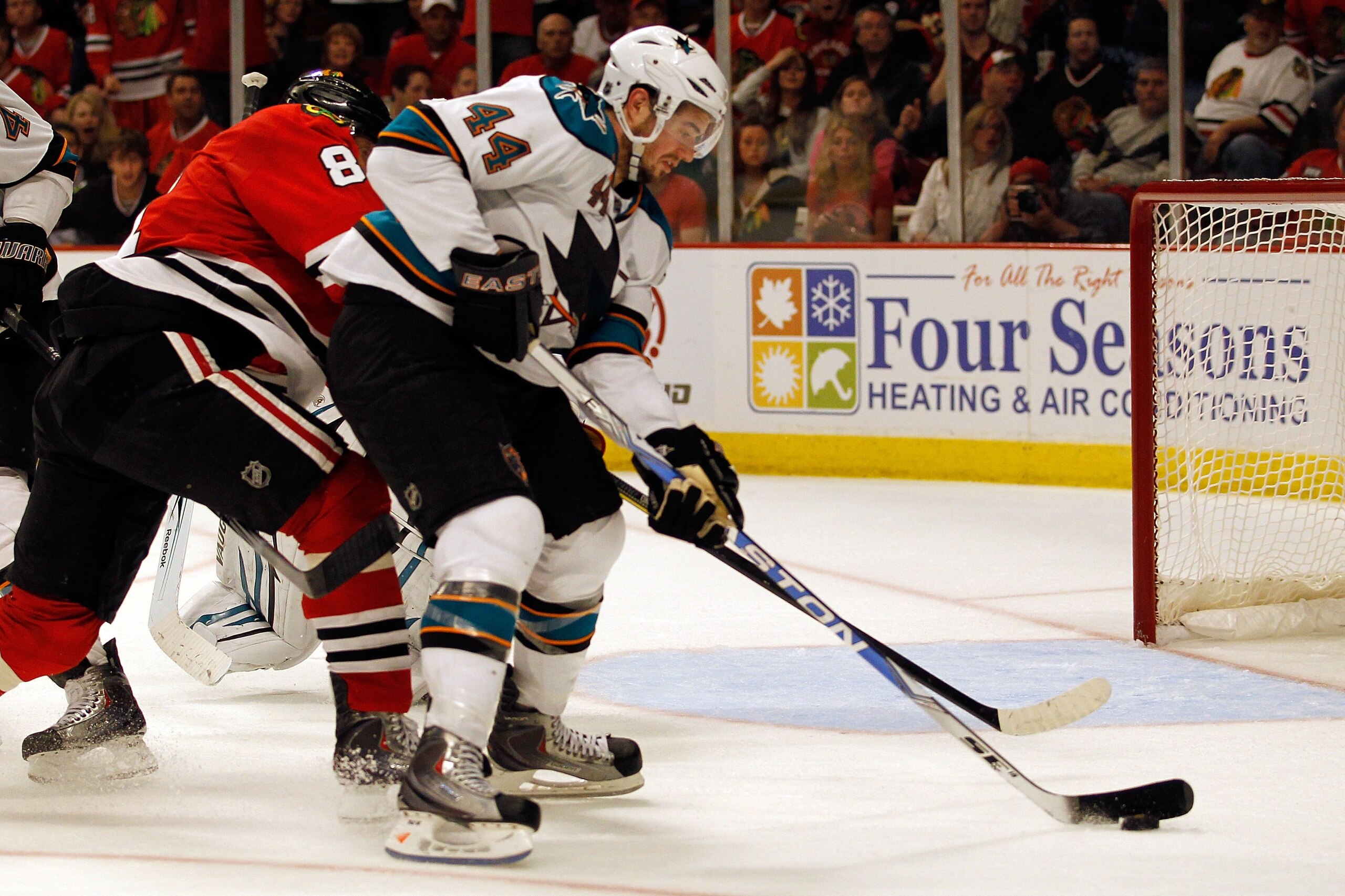 CHICAGO - MAY 21:  Marc-Edouard Vlasic #44 of the San Jose Sharks moves the puck while taking on the Chicago Blackhawks in Game Three of the Western Conference Finals during the 2010 NHL Stanley Cup Playoffs at the United Center on May 21, 2010 in Chicago