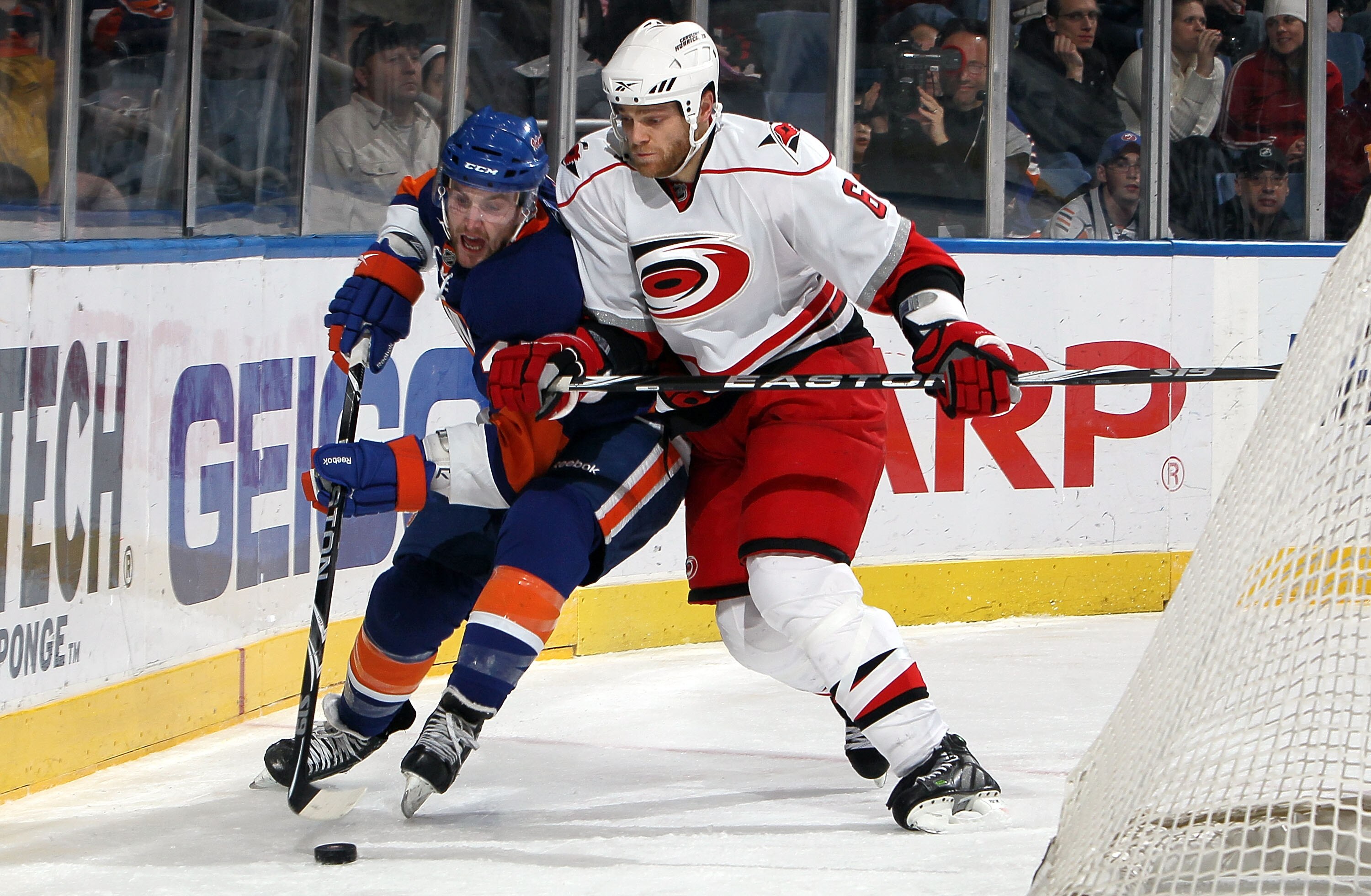 UNIONDALE, NY - FEBRUARY 06:  Tim Gleason #6 of the Carolina Hurricanes checks Andrew MacDonald #47 of the New York Islanders on February 6, 2010 at Nassau Coliseum in Uniondale, New York.  (Photo by Jim McIsaac/Getty Images)