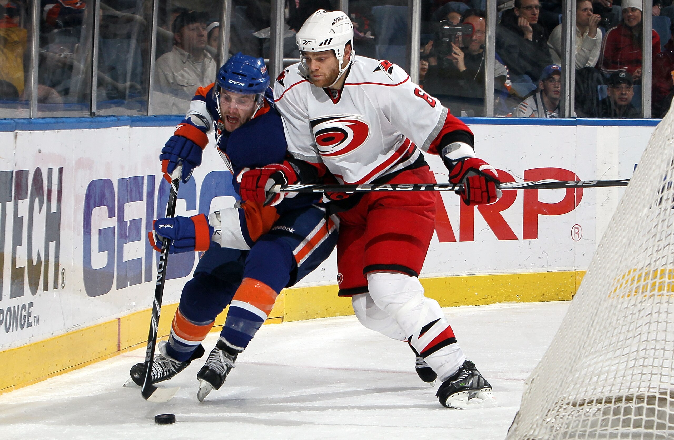 UNIONDALE, NY - FEBRUARY 06:  Tim Gleason #6 of the Carolina Hurricanes checks Andrew MacDonald #47 of the New York Islanders on February 6, 2010 at Nassau Coliseum in Uniondale, New York.  (Photo by Jim McIsaac/Getty Images)