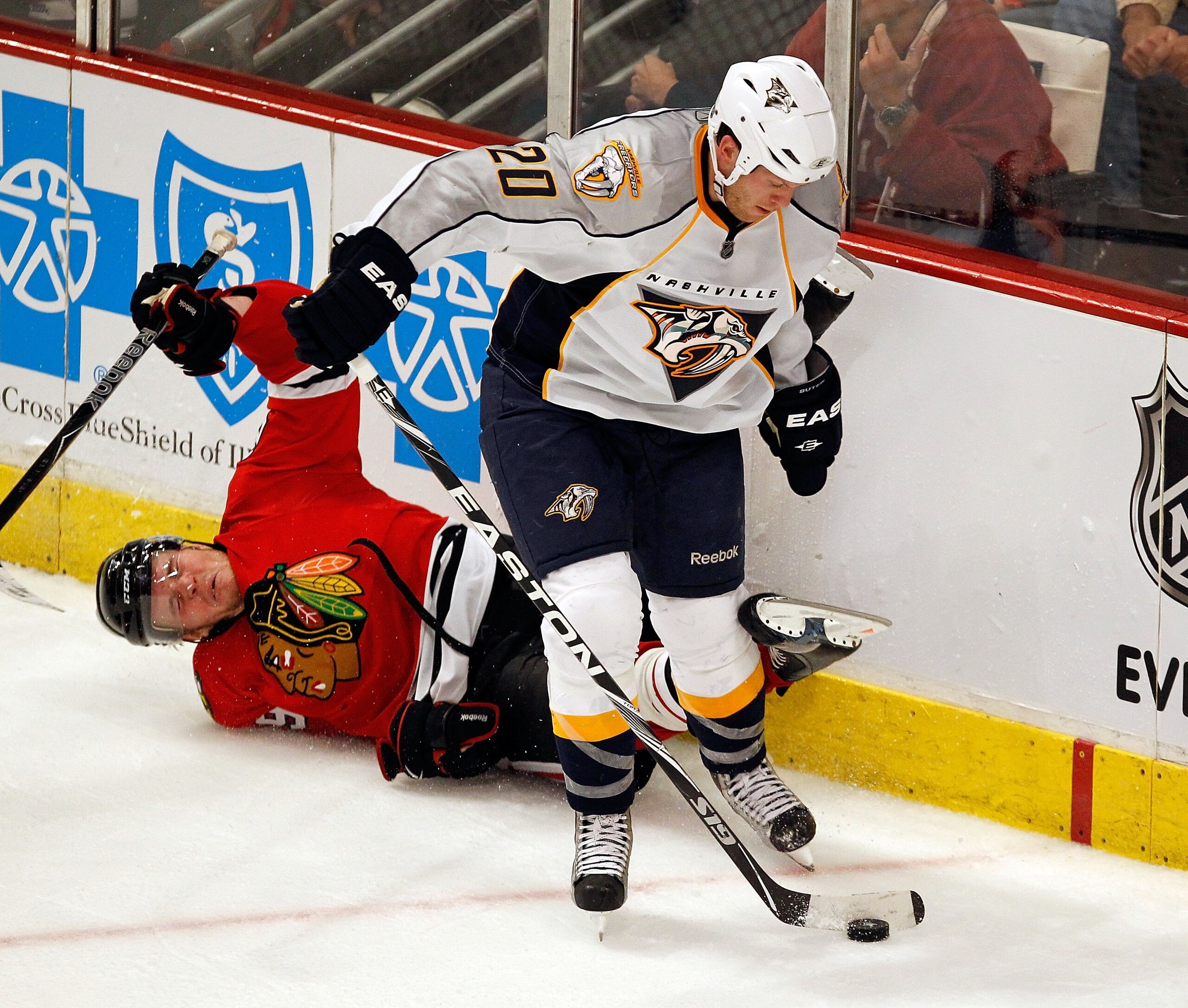 CHICAGO - APRIL 24: Bryan Bickell #29 of the Chicago Blackhawks falls to the ice after colliding with Ryan Suter #20 of the Nashville Predators in Game Five of the Western Conference Quarterfinals during the 2010 NHL Stanley Cup Playoffs at the United Cen